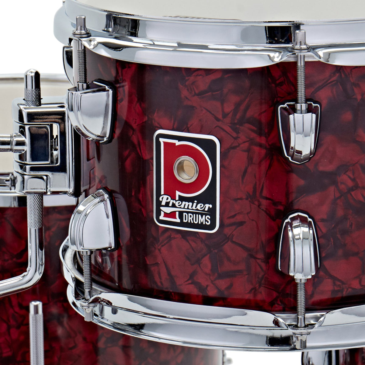 Close-up of the Premier badge and chrome tension lugs on a drum from the Premier Artist Heritage 16-inch 4-piece shell pack in Burgundy Pearl