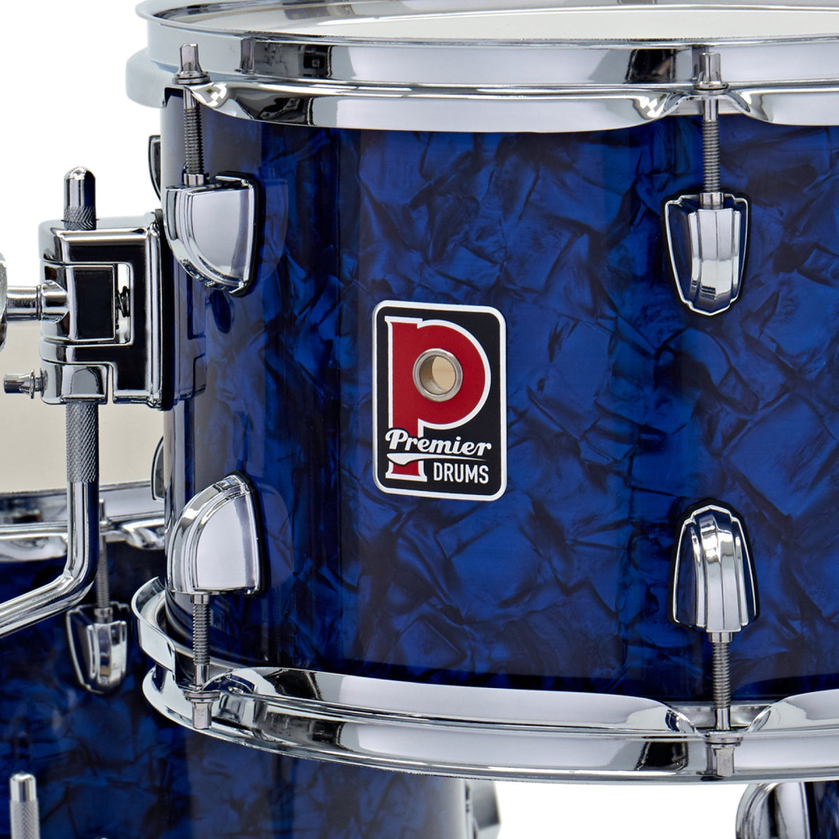 Close-up of the Premier badge and chrome tension lugs on a drum from the Premier Artist Heritage 18-inch 4-piece shell pack in Blue Pearl