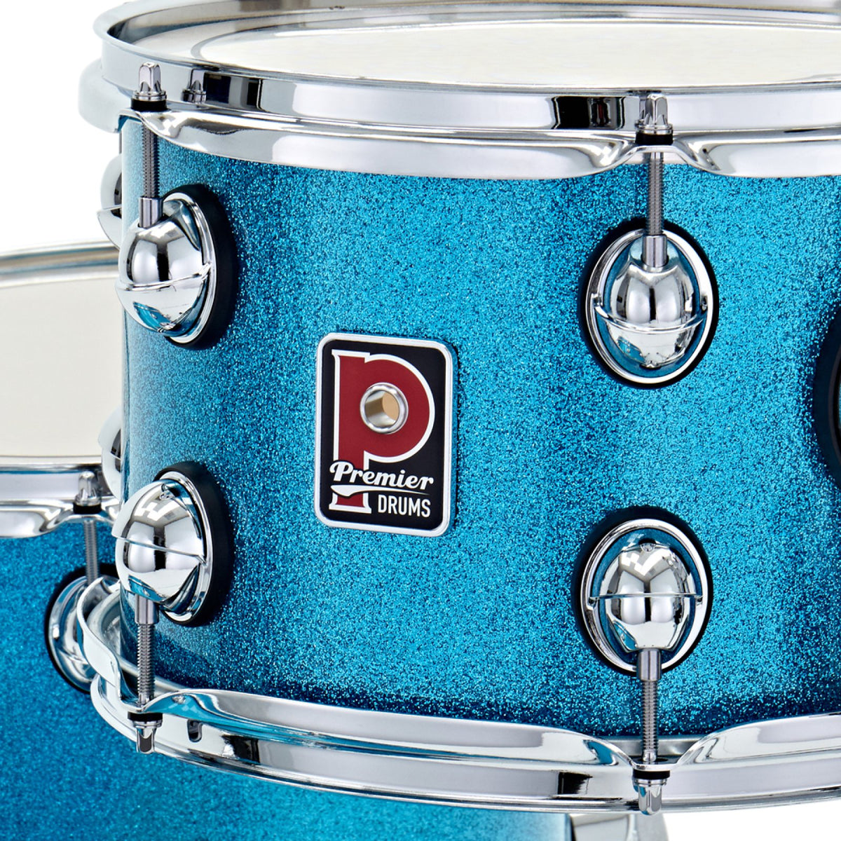 Close-up of the Premier badge and chrome tension lugs on the rack tom of the Premier Genista Heritage 3-piece 18-inch shell pack in Aqua Sparkle