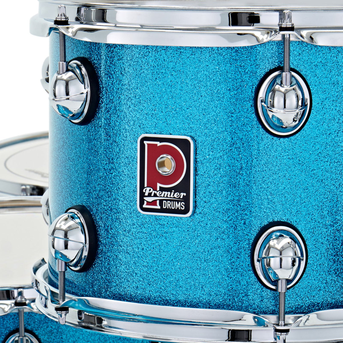 Close-up of the Premier badge, tension lugs and chrome hoop on an Aqua Sparkle Premier Genista Heritage tom