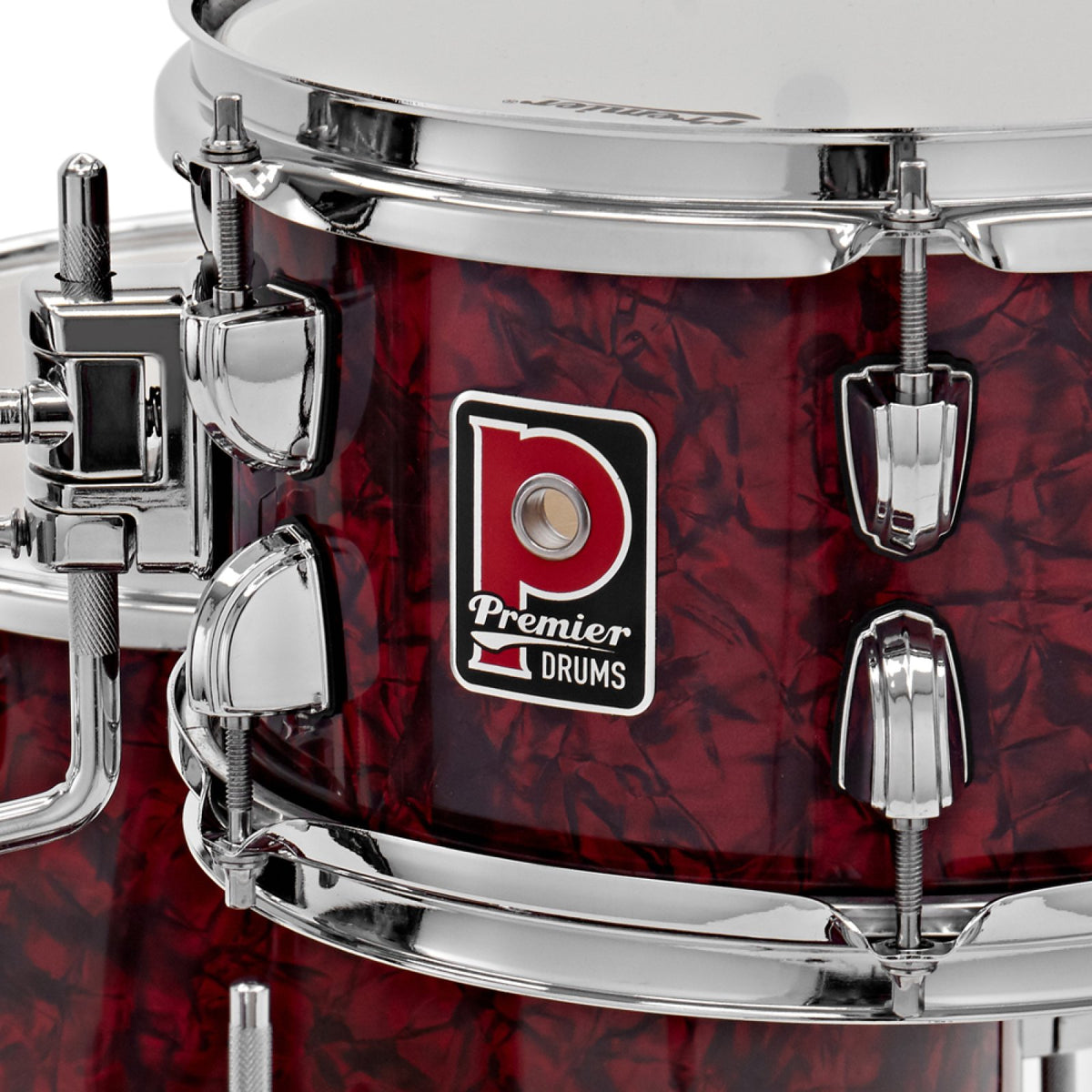 Close-up of the Premier badge and chrome tension lugs on a drum from the Premier Artist Heritage 20-inch 4-piece shell pack in Burgundy Pearl