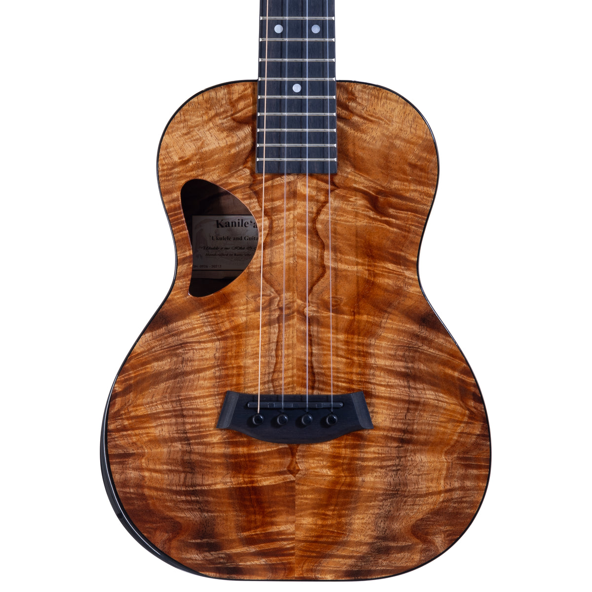 Upper bout of Kanile'a DK-T Pro tenor ukulele serial 30212 showing the koa top grain and the label inside the soundhole