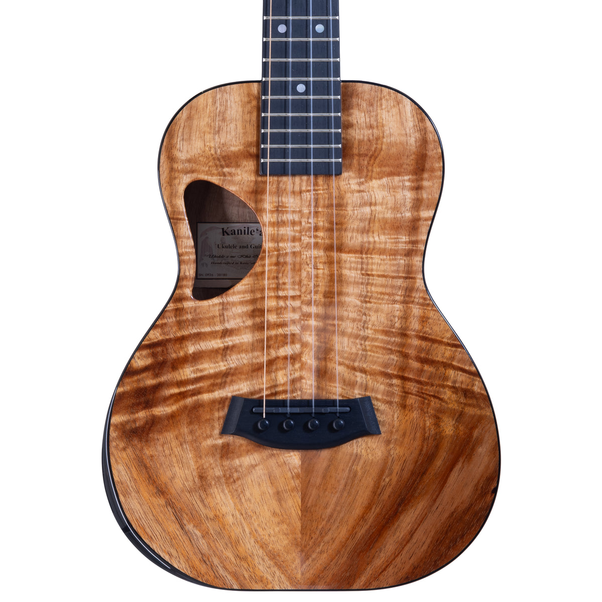 Upper bout of Kanile'a DK-T Pro tenor ukulele serial 30180 showing the koa top grain and the label inside the soundhole