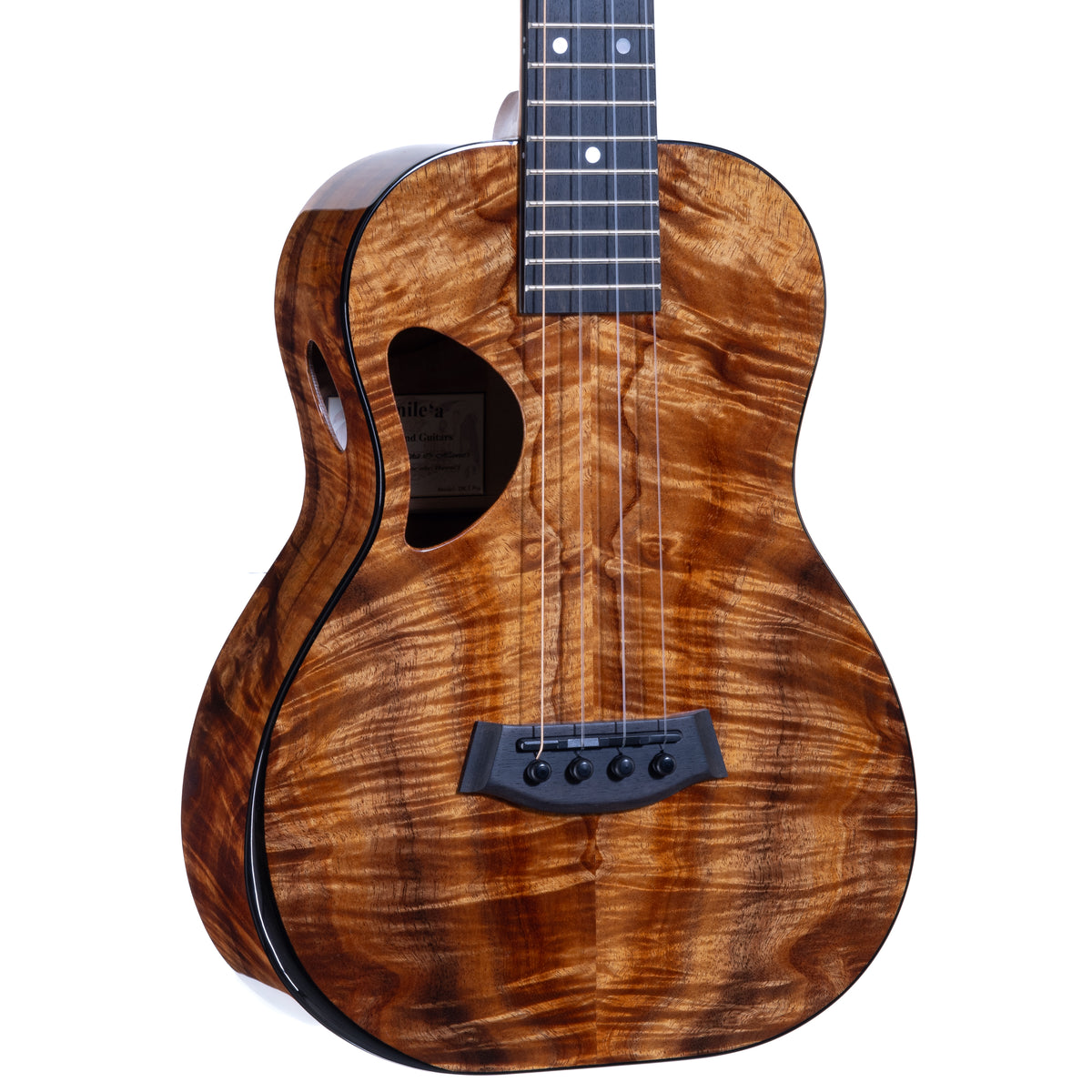 Close-up of the figured koa top, ebony bridge and D-shaped soundhole with oval side sound port on Kanile'a DK-T Pro tenor ukulele, serial 30212