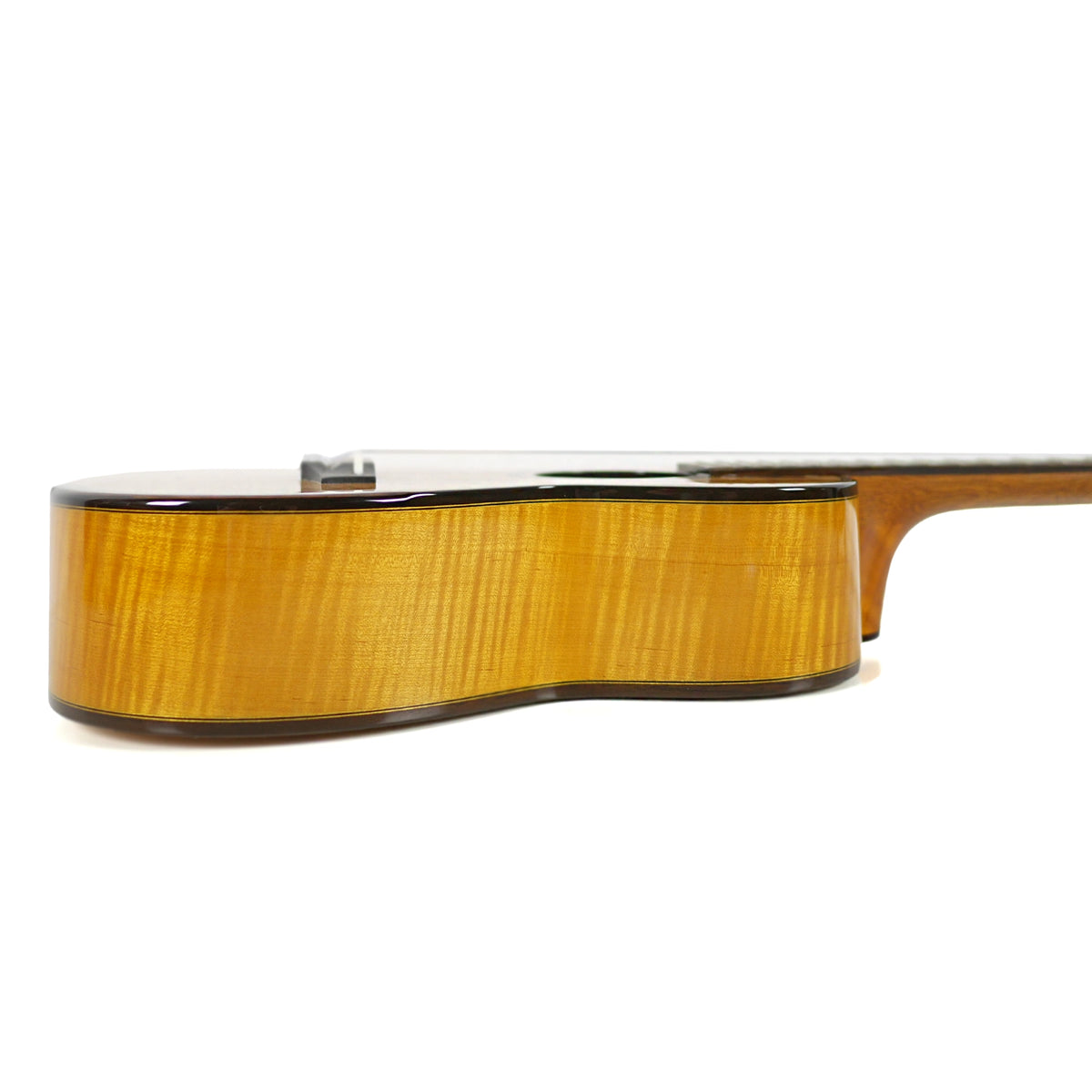 The side view of the Ohana CK-450SMP Concert Ukulele showcases its solid spalted maple sides, gloss finish, and wood binding.