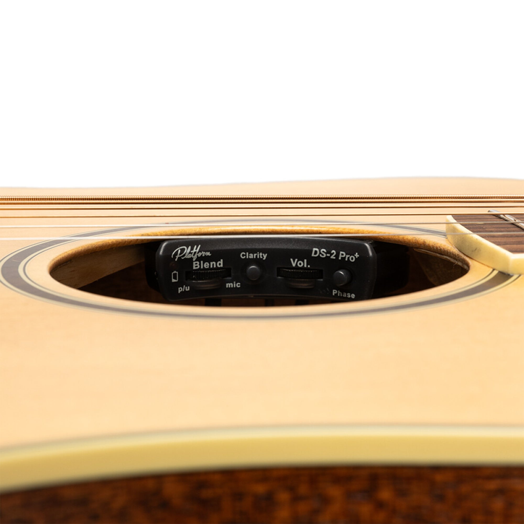 Close-up of an acoustic guitar with a pickup and control panel on a white background