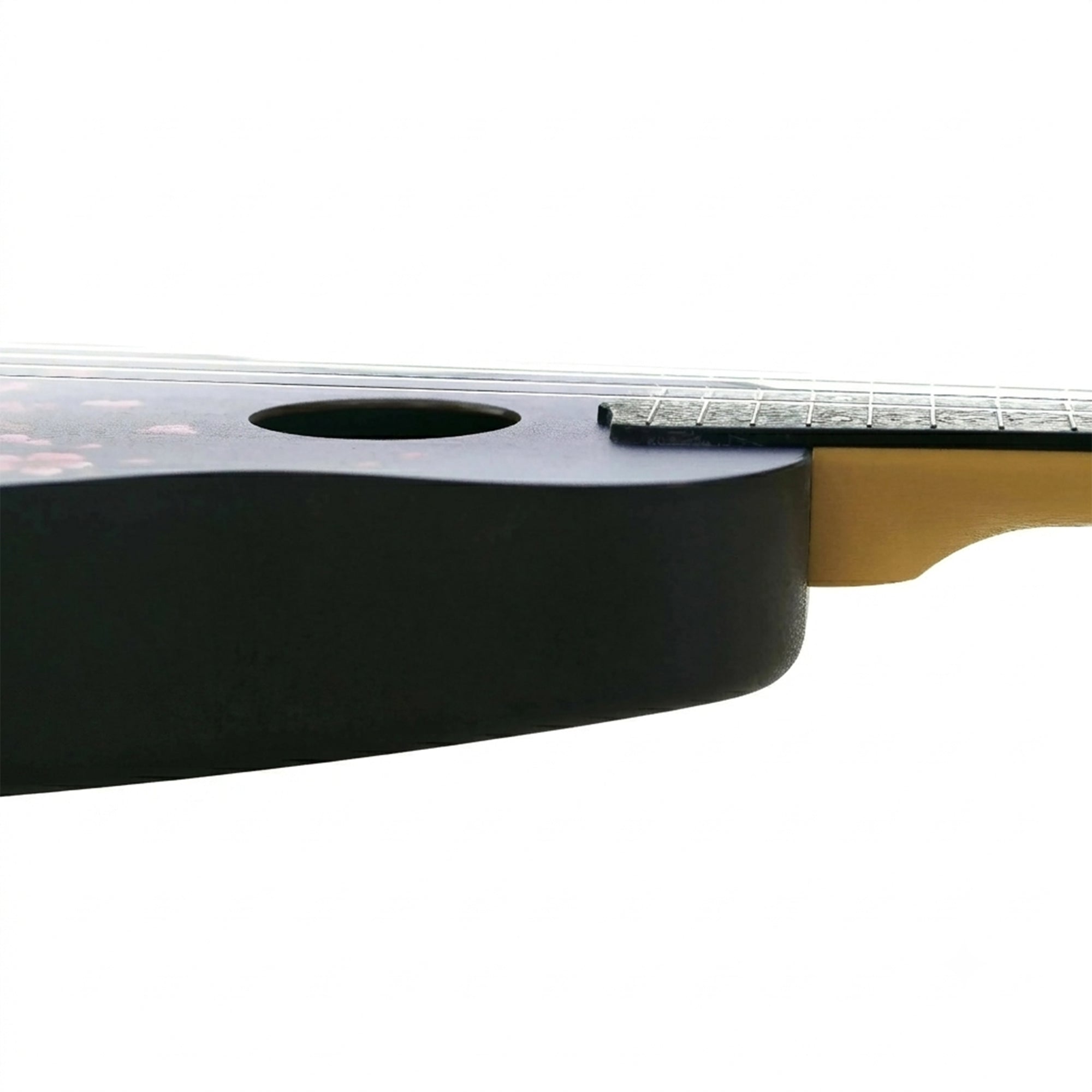 Close-up of a Flight TUS32 Sakura and neck joint, showing a matte black soundboard, part of the fretboard, and a natural wood headstock on a white background.