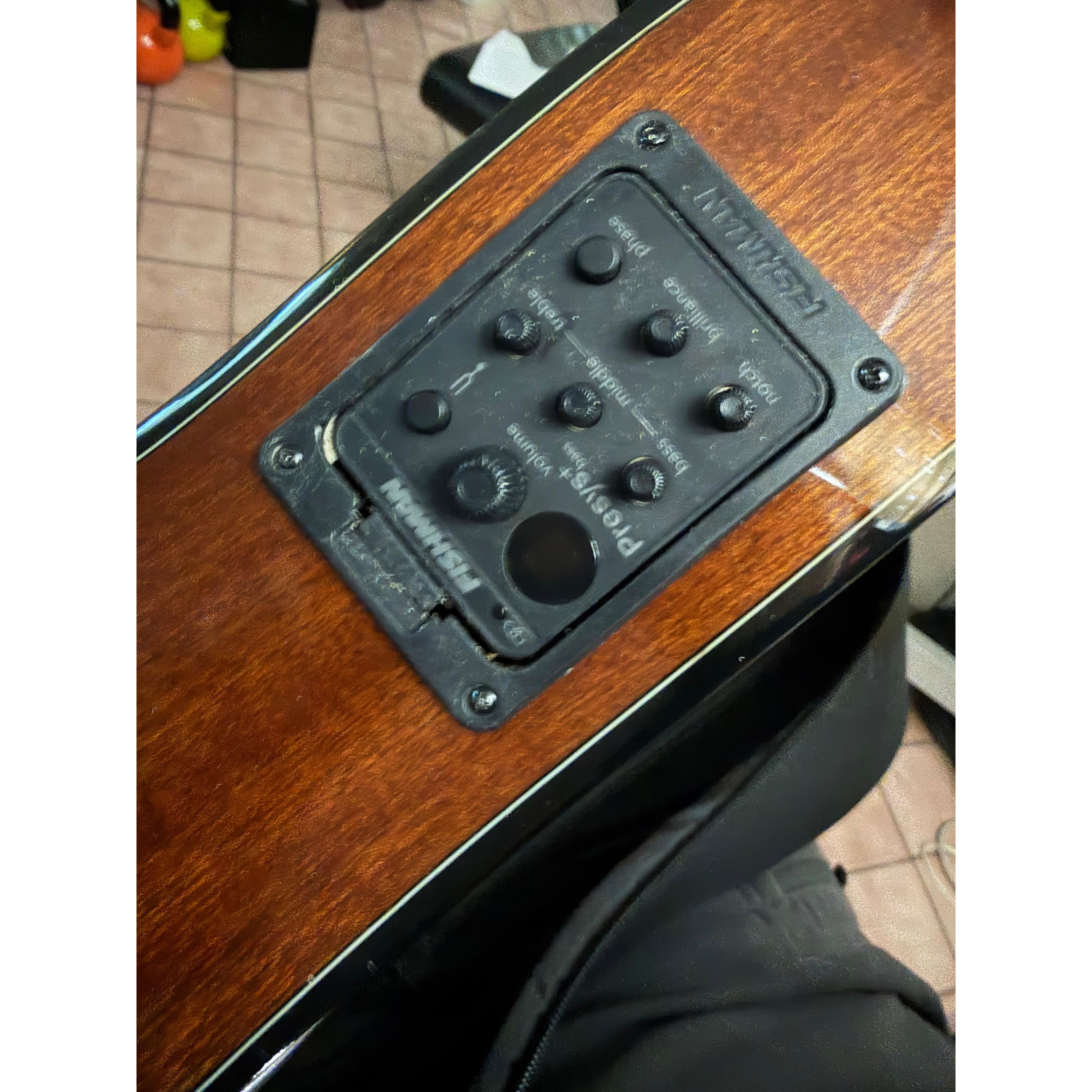 Close view of the Fishman Presys+ preamp on the Ohana OBU-22 side, showing the blemish at the panel edge