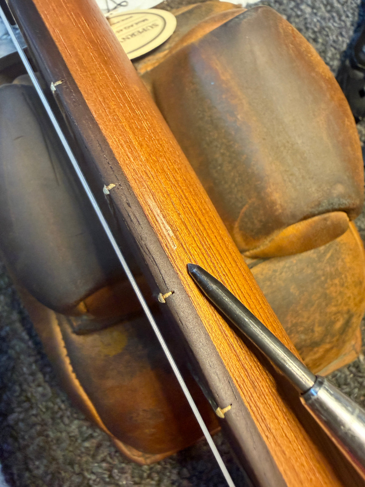 Blemish on this Kala JT-T-CE tenor ukulele: small chip of wood missing on the underside of the neck