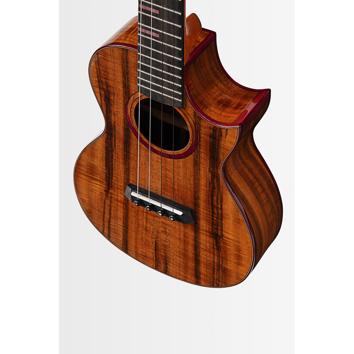 Angled view of the Kala KA-3CD-ACA-T showing the Florentine cutaway and purpleheart binding