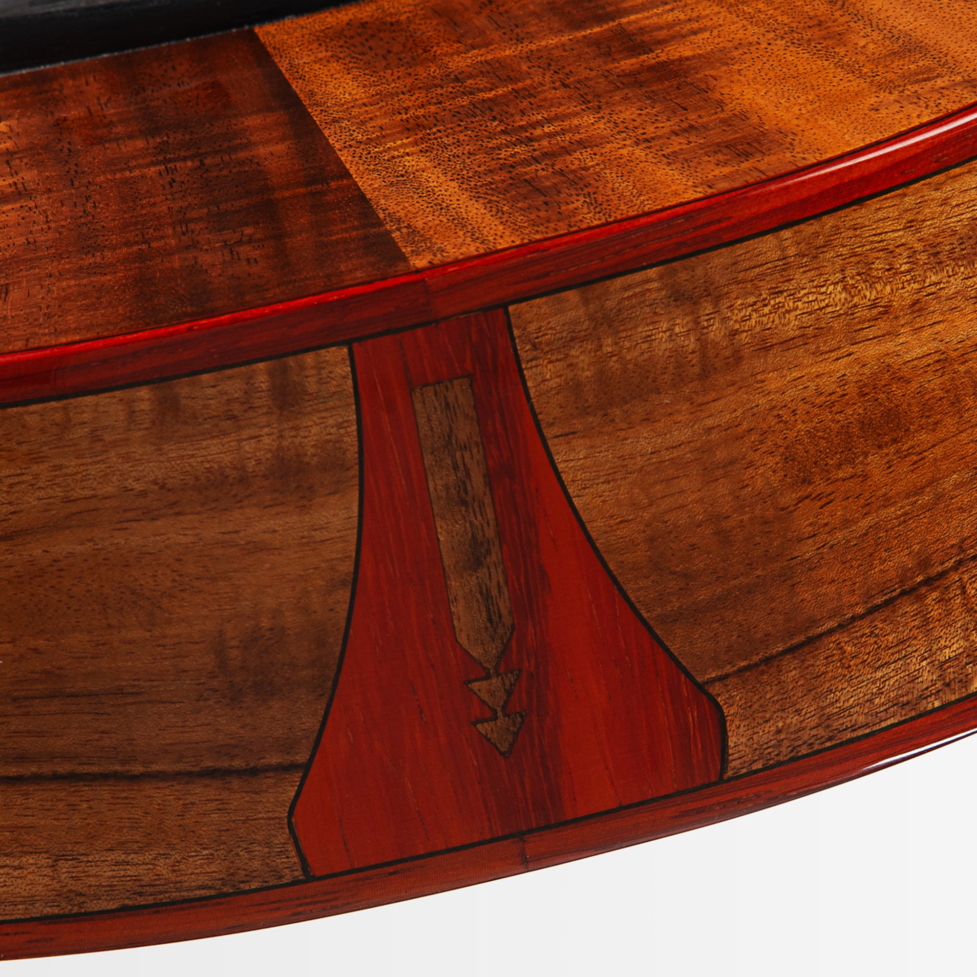 Close-up of a wooden instrument body showing rich reddish-brown wood grain, a red varnish edge, and a decorative inlay detail on a white background.