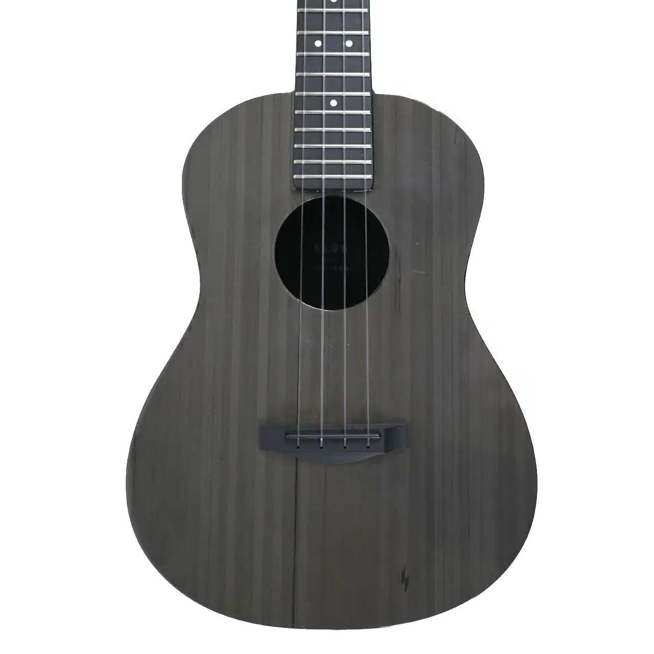 Klōs Carbon Timber tenor ukulele with a dark wood-grain finish, composite ebony fretboard, and sleek acoustic body.