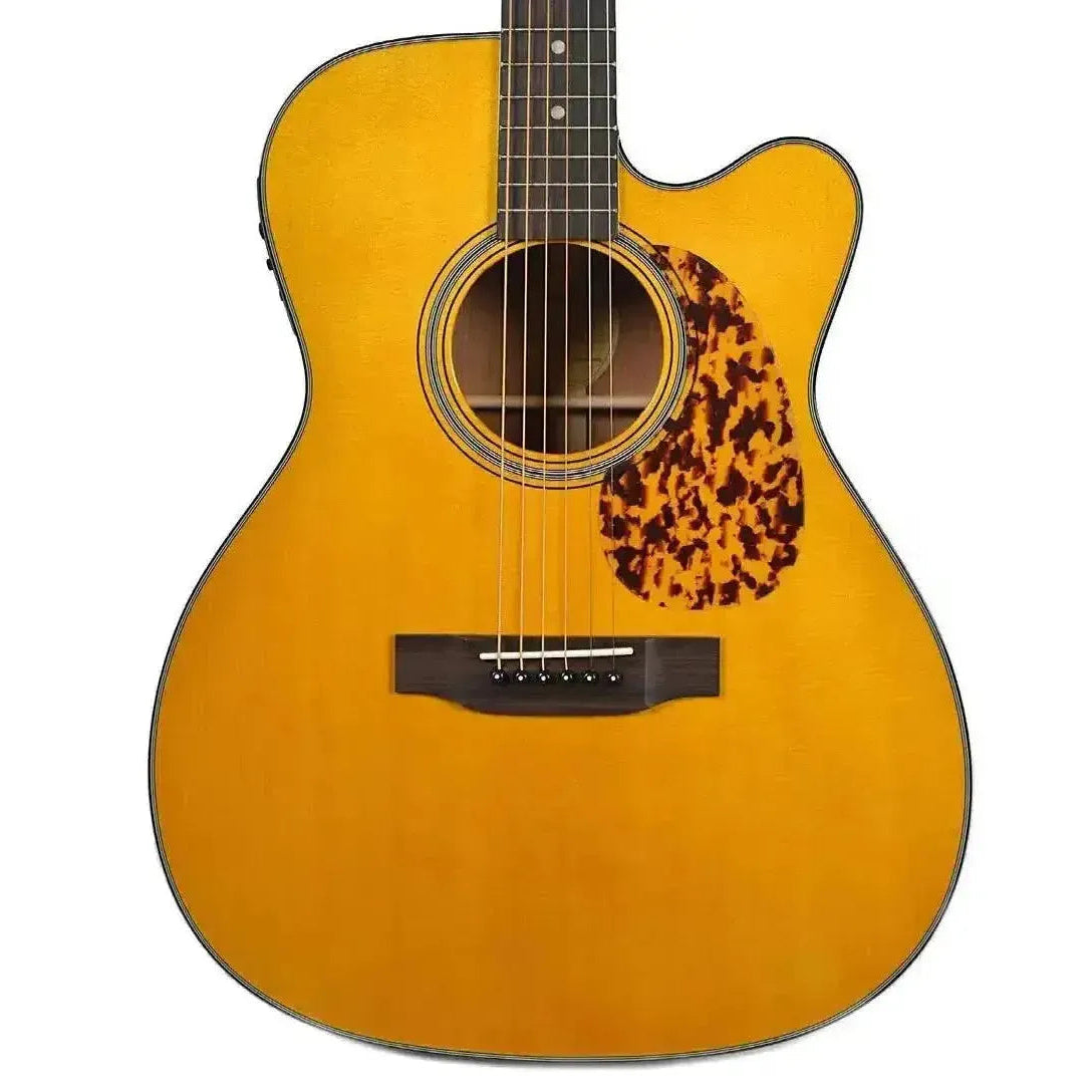 Blueridge BR-143CE 000 acoustic-electric guitar with a vintage yellow finish, tortoise pickguard, and Venetian cutaway.