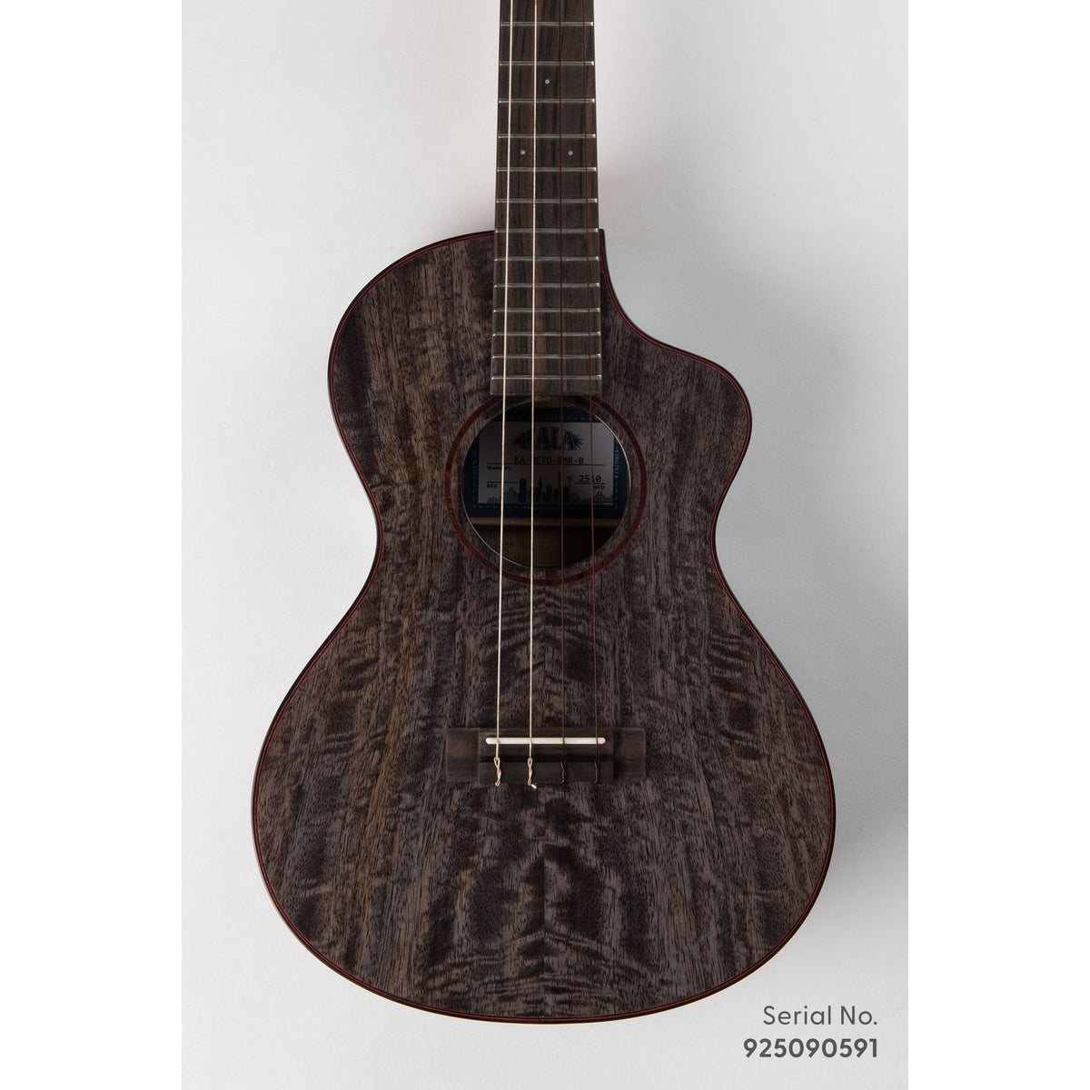 Kala METD-BMR-B Metropolitan Deluxe baritone ukulele, serial 925090591, front view showing the solid mango top's dark figured grain and ebony rosette with red purfling