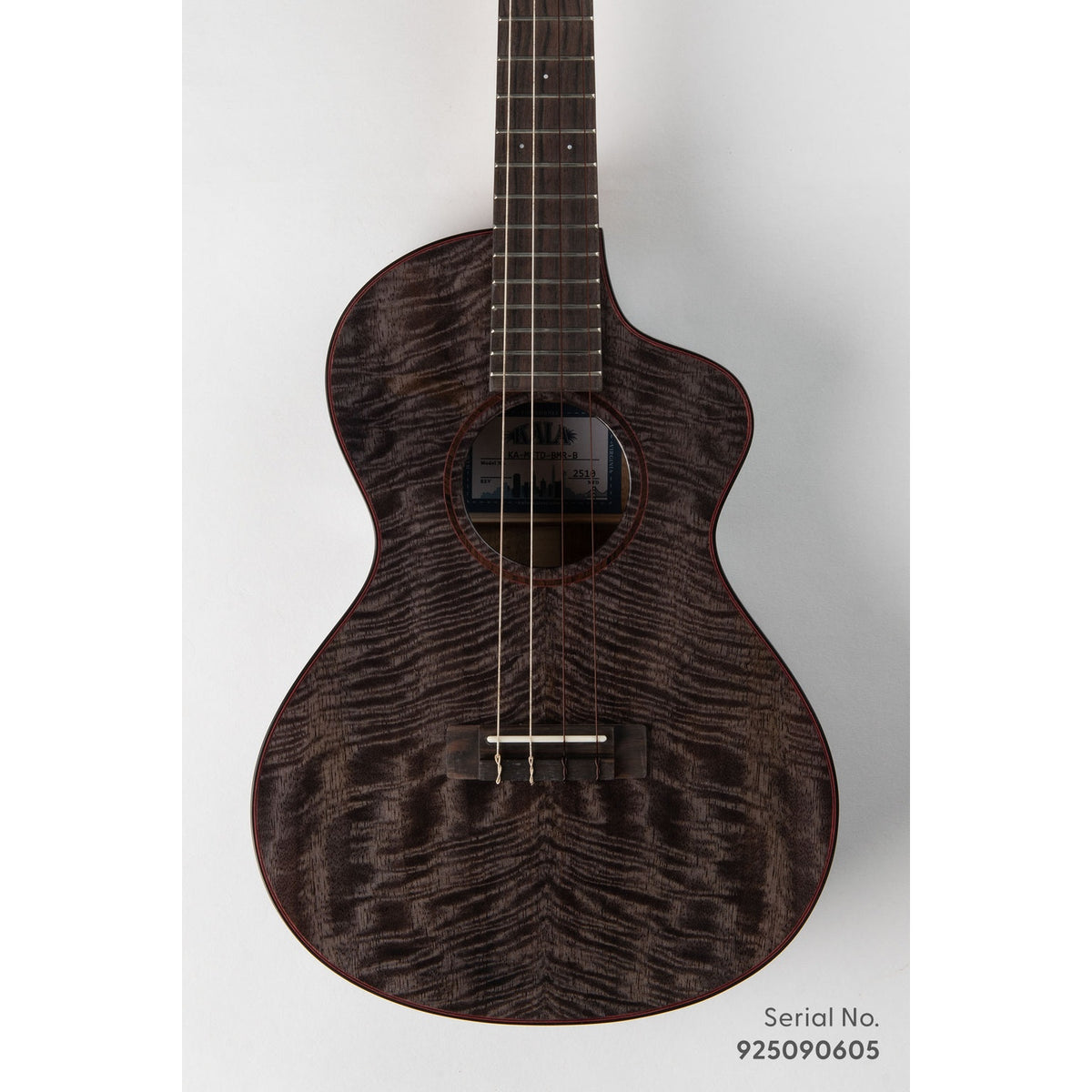 Kala METD-BMR-B Metropolitan Deluxe baritone ukulele, serial 925090605, front view showing the solid mango top's dark figured grain and ebony rosette with red purfling