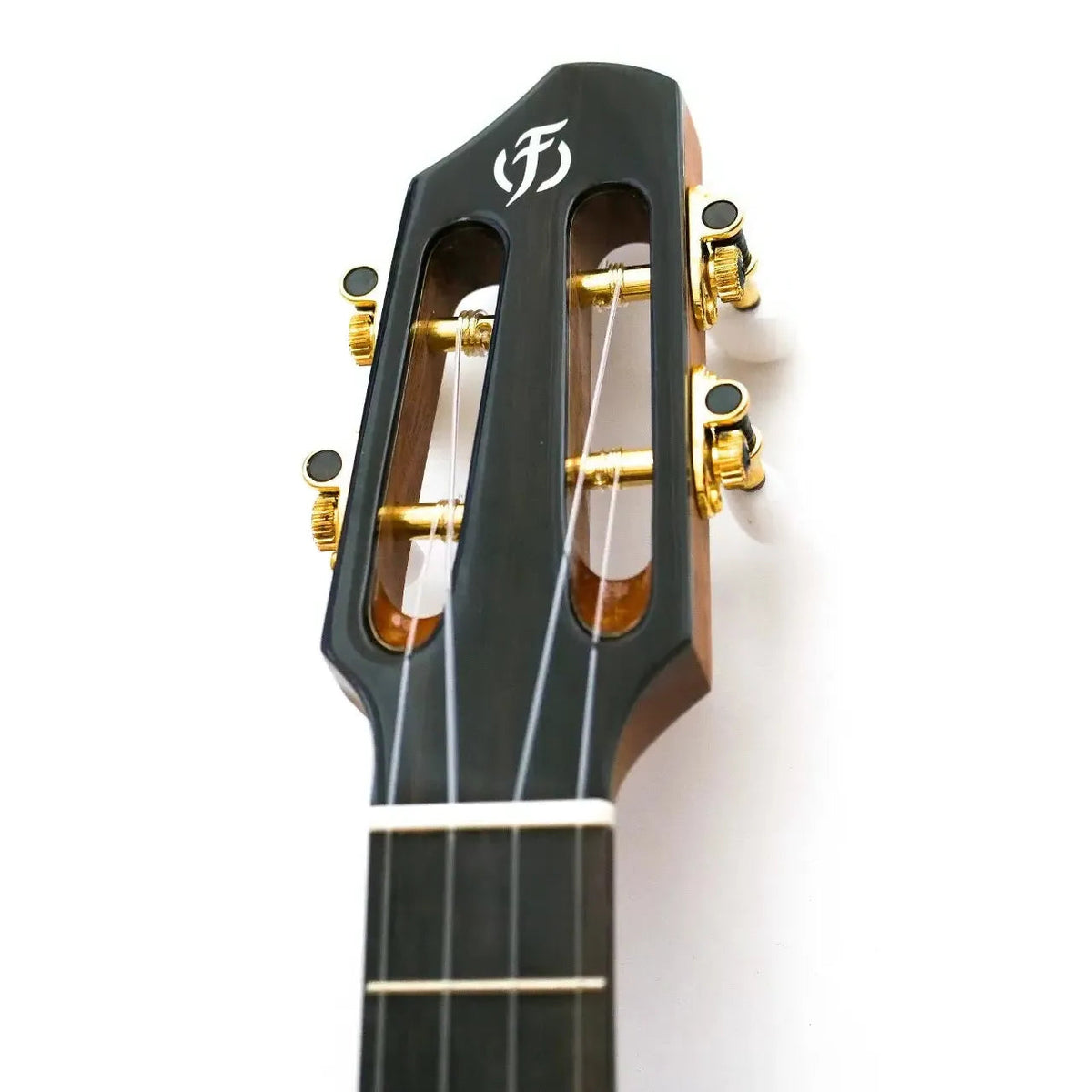 Flight A10 SC Tenor Ukulele slotted headstock with gold tuners and white logo on dark wood.