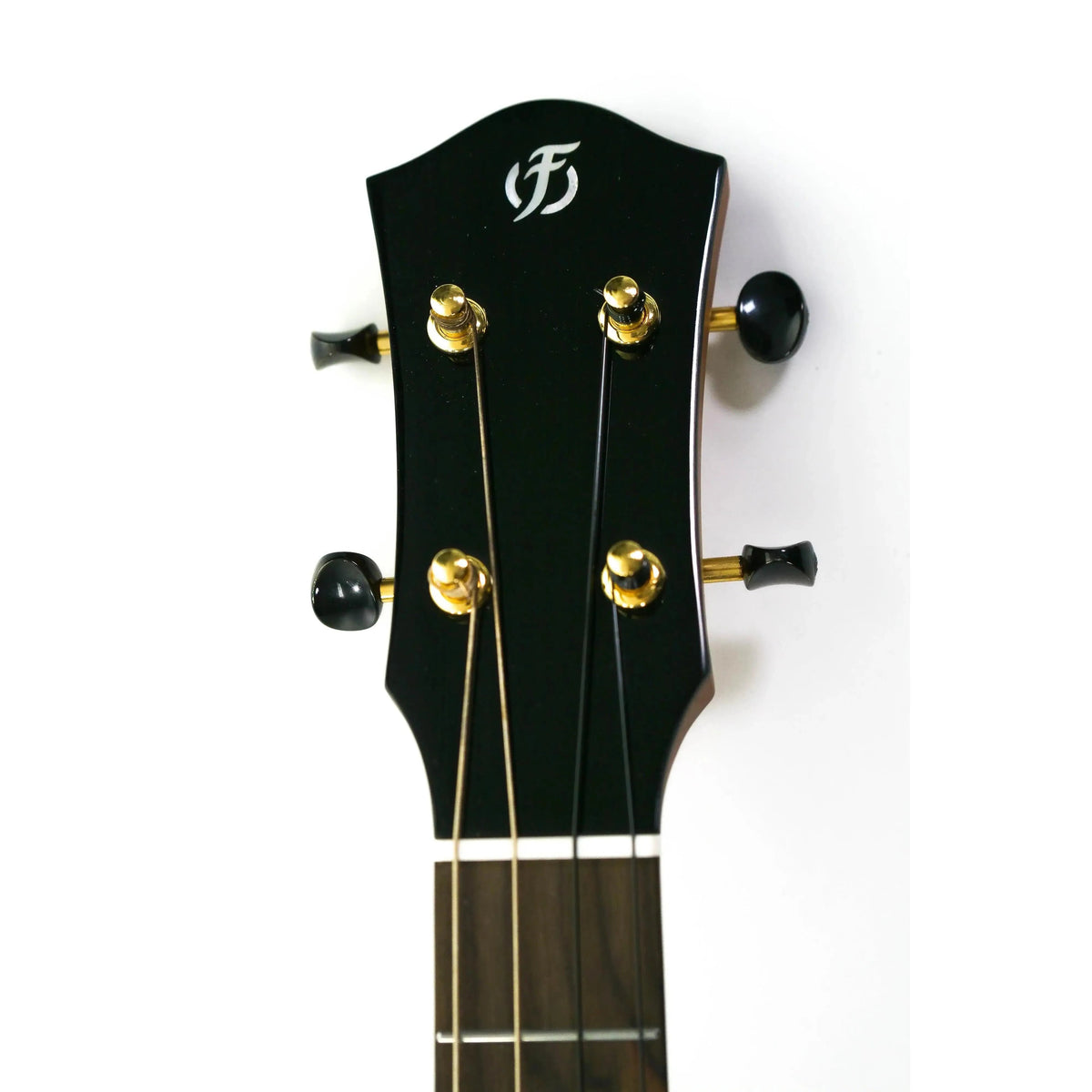 Flight Aurora EQ-A Baritone Ukulele headstock with black finish, gold tuners, and white Flight logo.