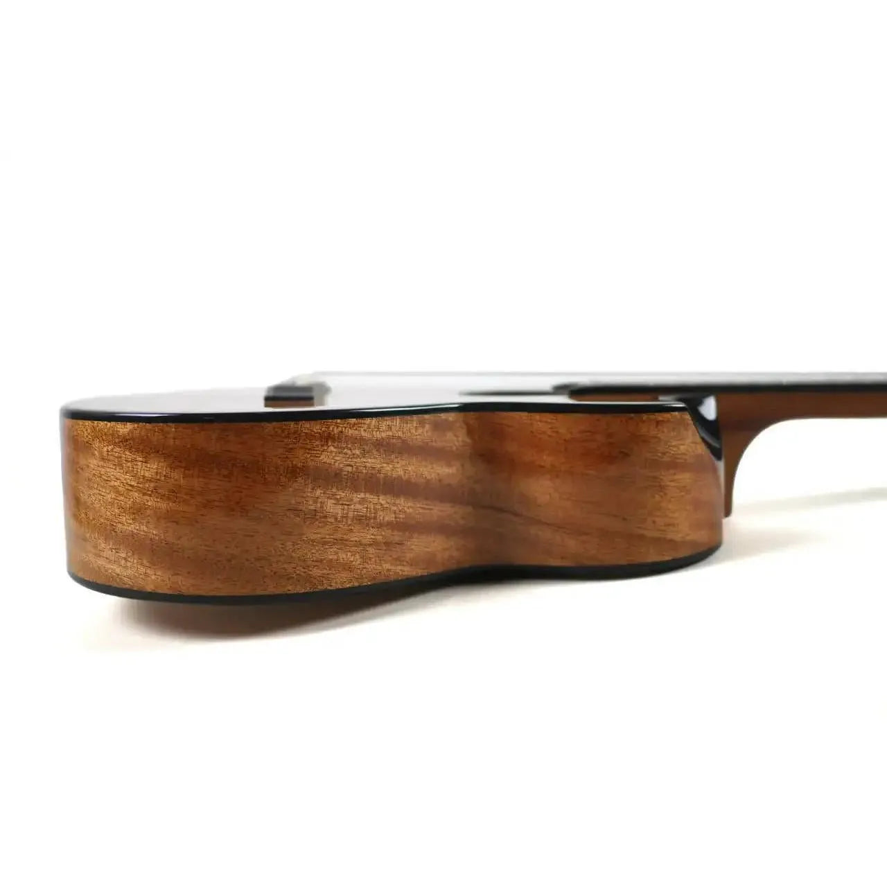 Side view of a Flight Nomad Tenor Ukulele, showcasing its glossy, solid mahogany body with rich wood grain.