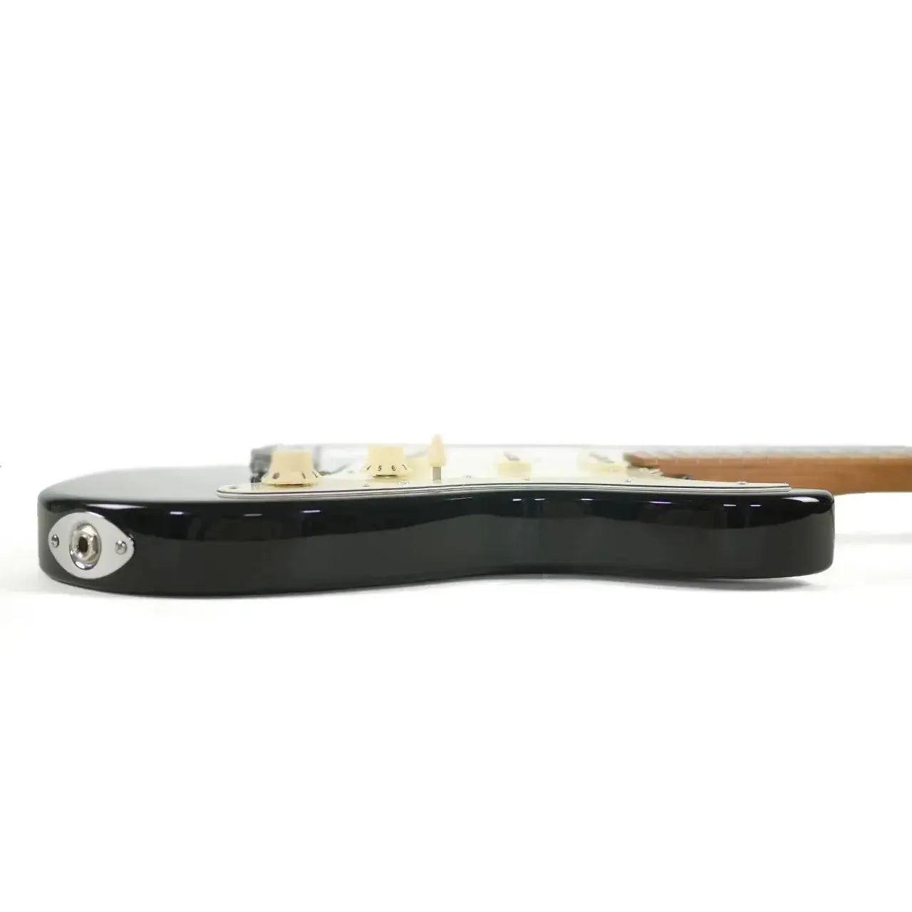 Side view of a black Jet JS-300 MINI Stratocaster electric guitar body with input jack.