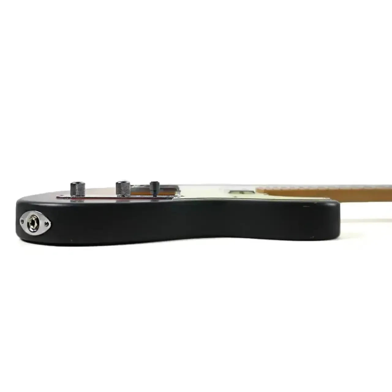 Side view of a Jet JT-350-RLC Telecaster electric guitar body with black finish and output jack.