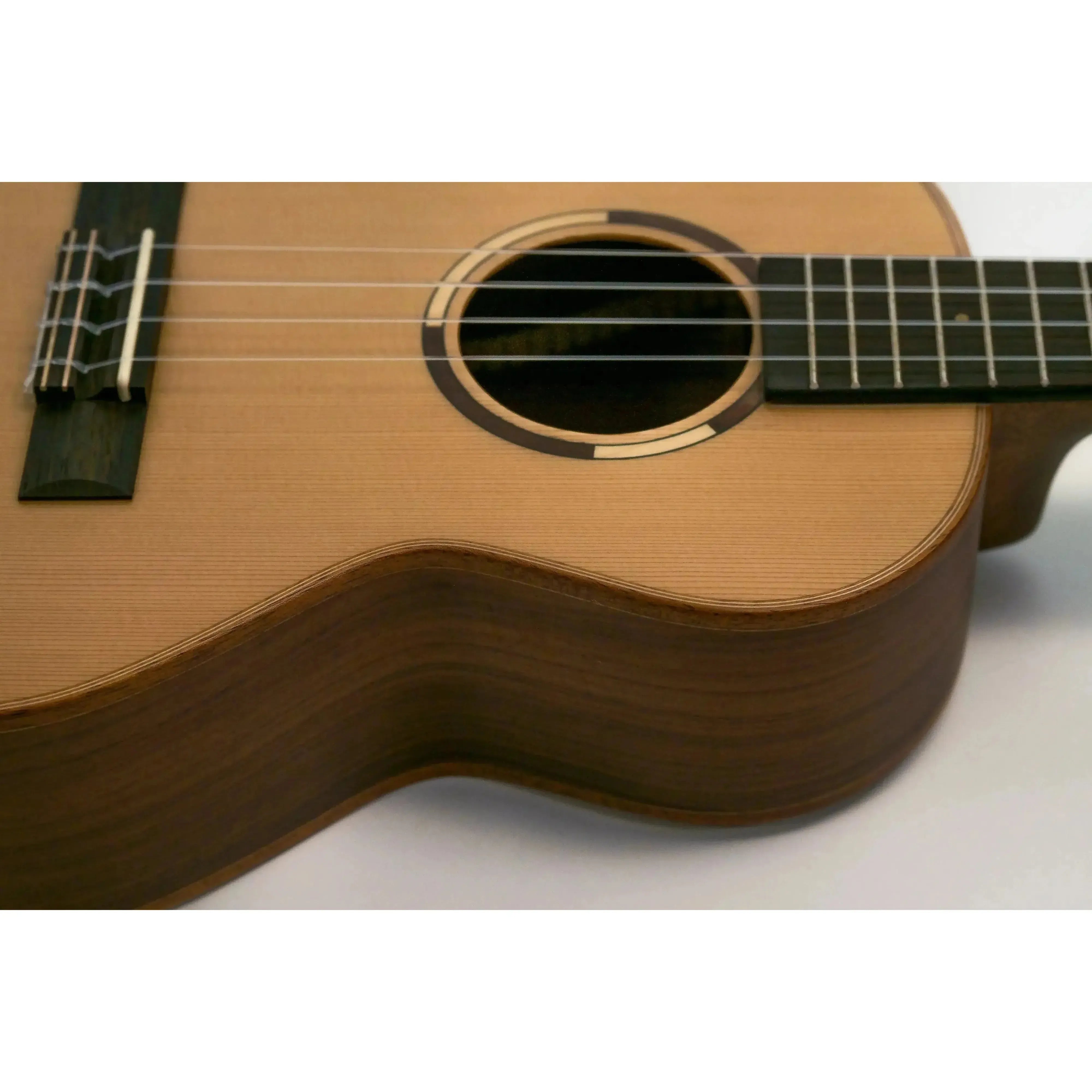 Kala ASCP-T tenor ukulele with solid cedar top, pau ferro sides, striped ebony fretboard, and slotted headstock.