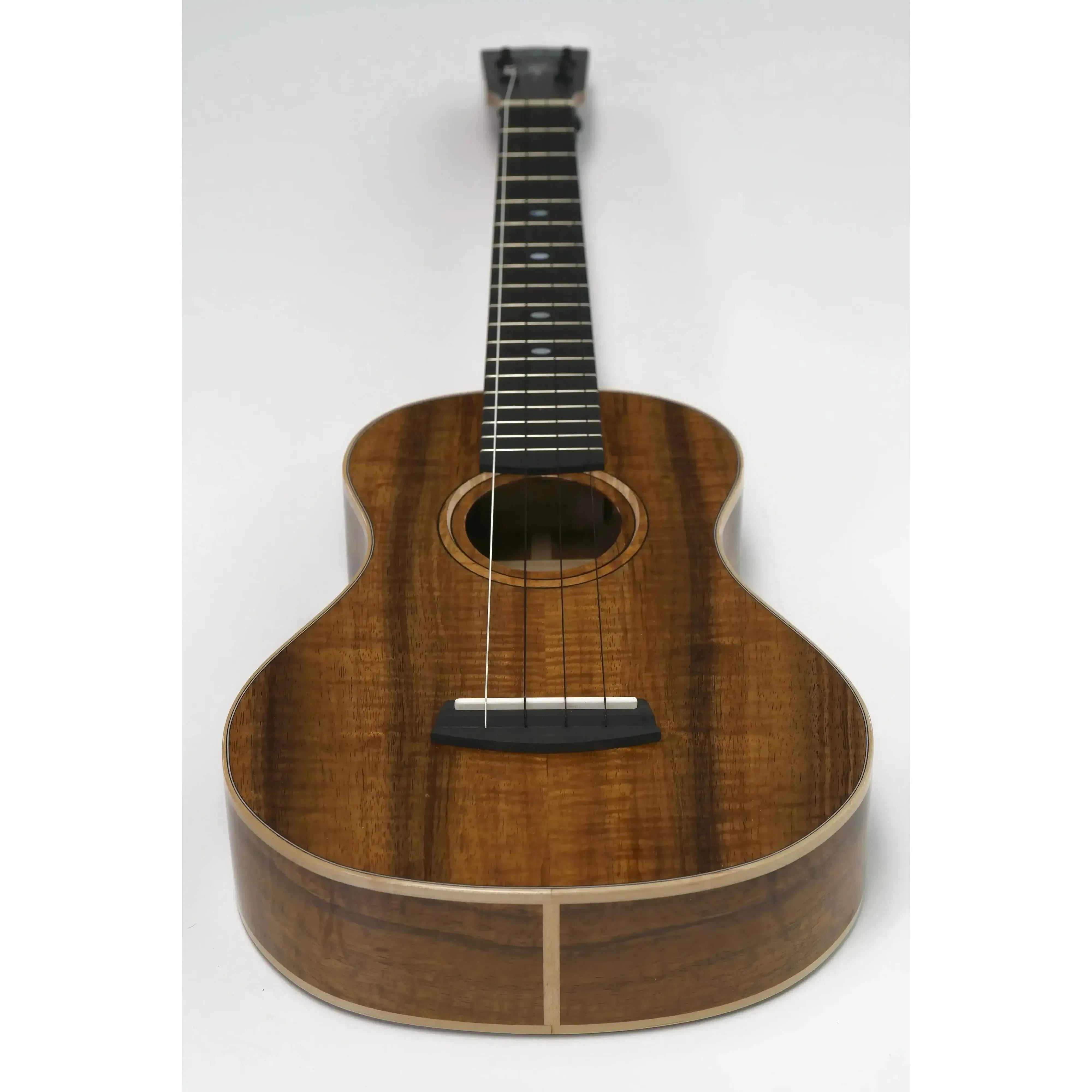 Kala Elite KOA-STG Solid Koa Super Tenor XL Ukulele with dark wood grain and light binding.