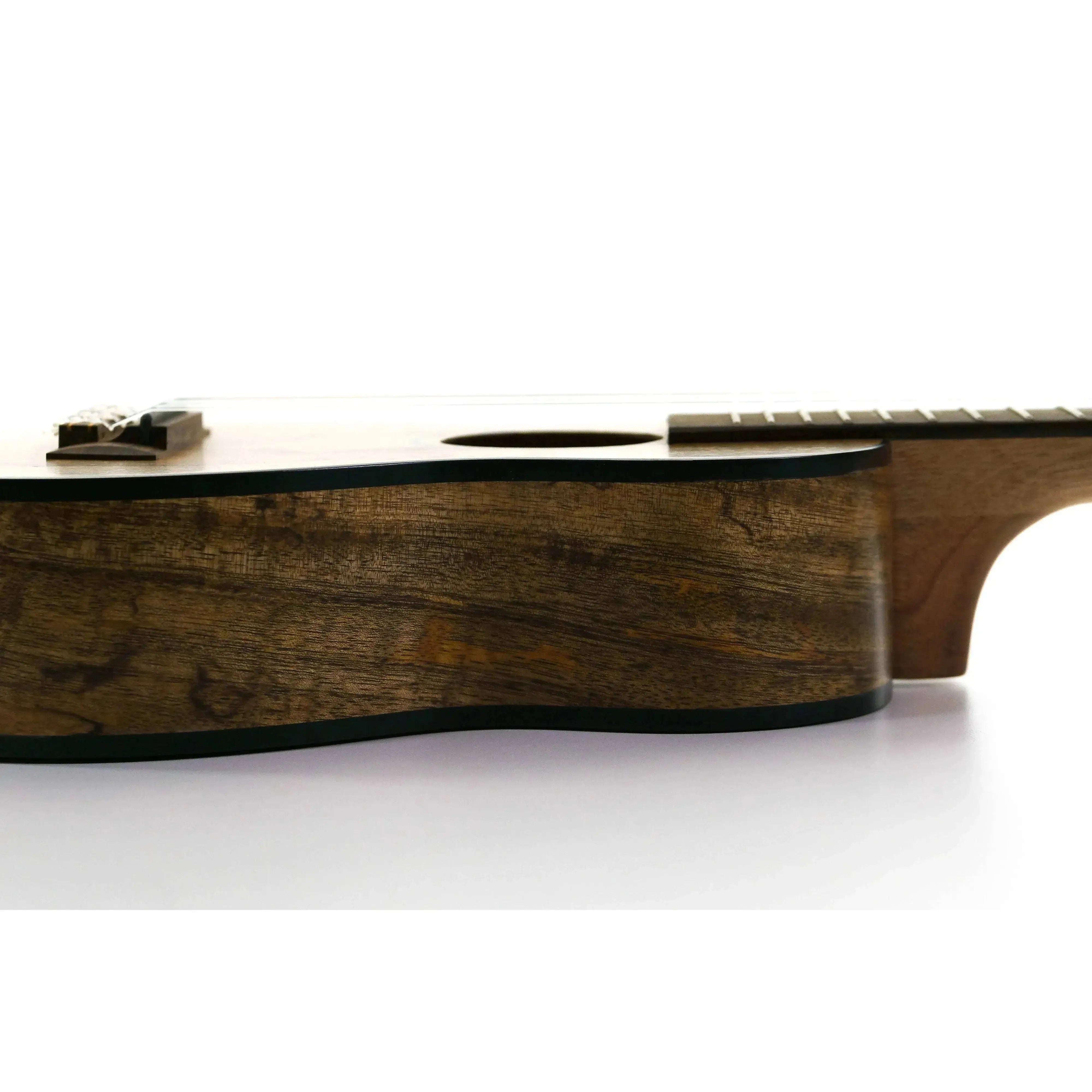 Kala MG-SLNG Spalted Mango Longneck Soprano Ukulele side view, showing dark wood grain and black binding.