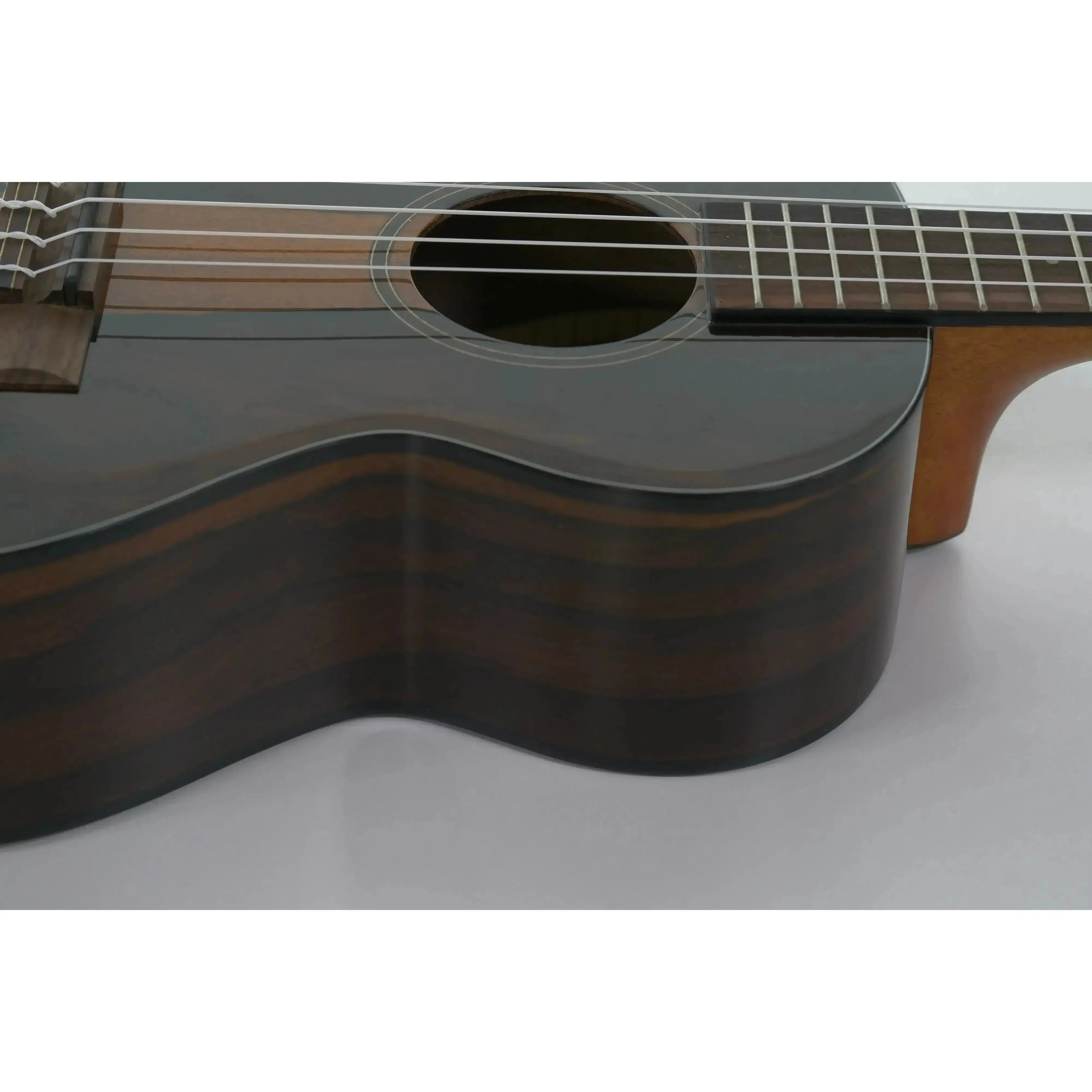 Kala ZCT-T Gloss Ziricote Tenor Ukulele with dark wood grain, soundhole, and fretboard.