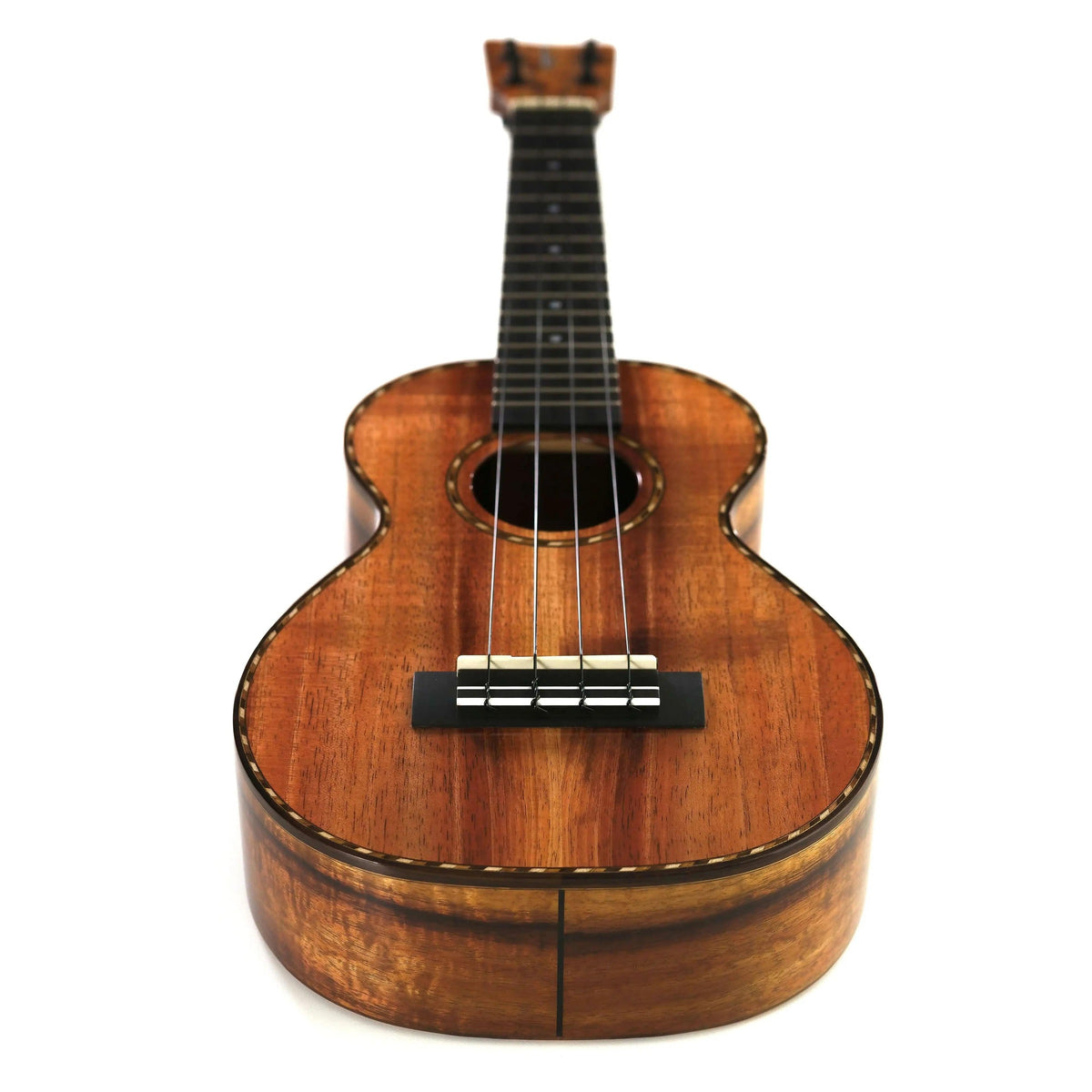 Kamaka HF-2-D concert ukulele full view at an angle showing curly koa top, ebony bridge and side