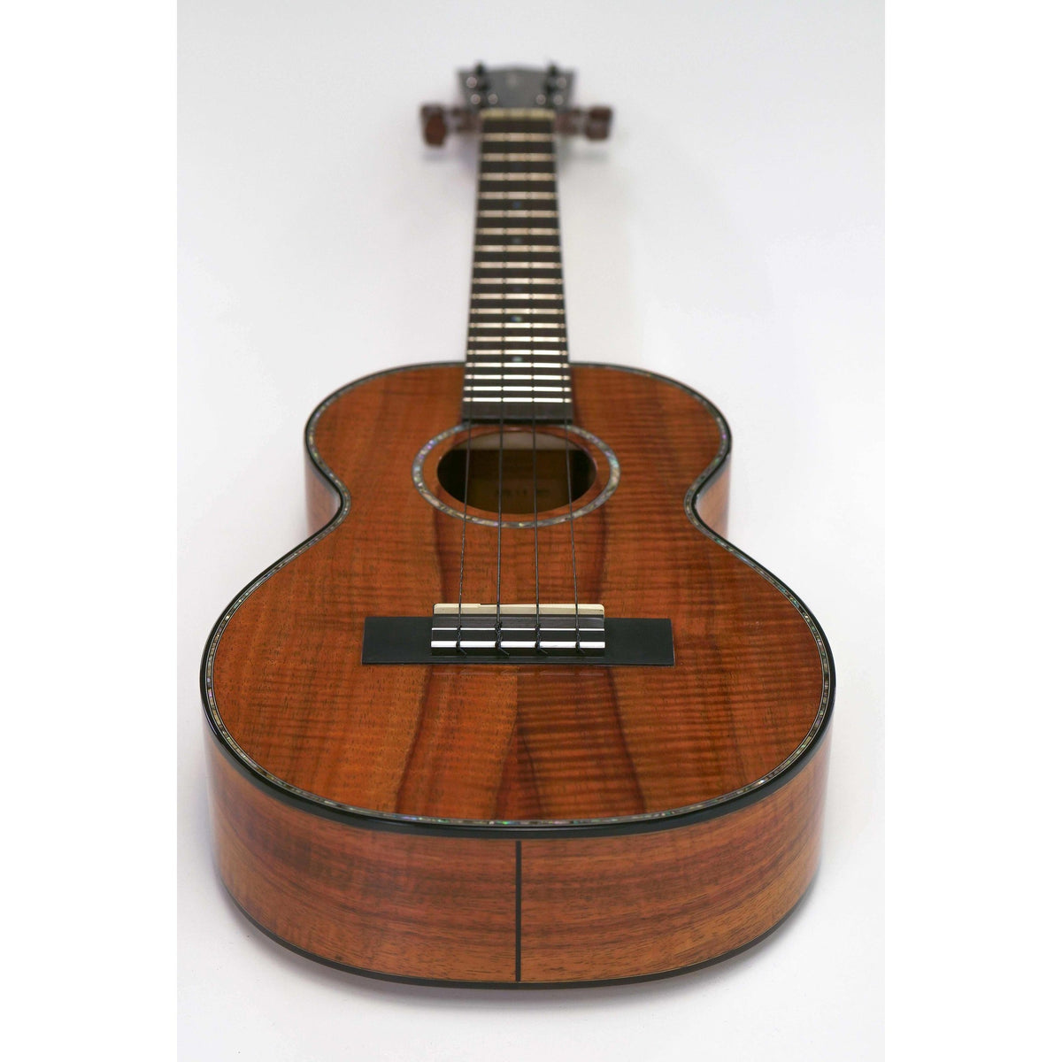 Kamaka HF-3-D2 tenor ukulele full front view at an angle showing curly koa body and abalone purfling