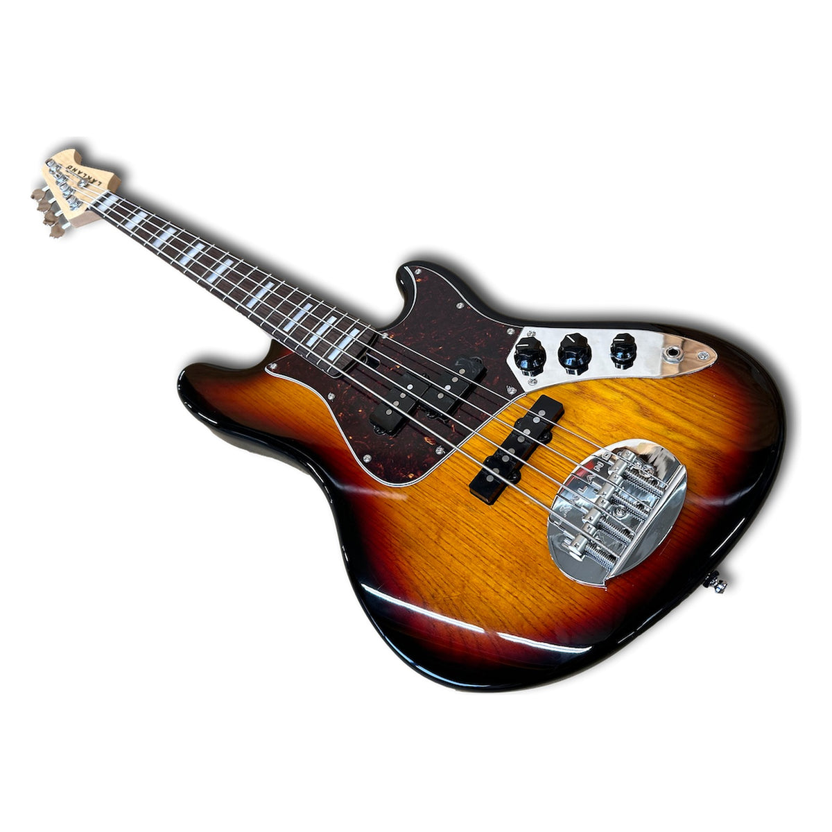 Angled view of the Lakland HH-30 sunburst body with P and J pickups, tortoise pickguard and chrome bridge