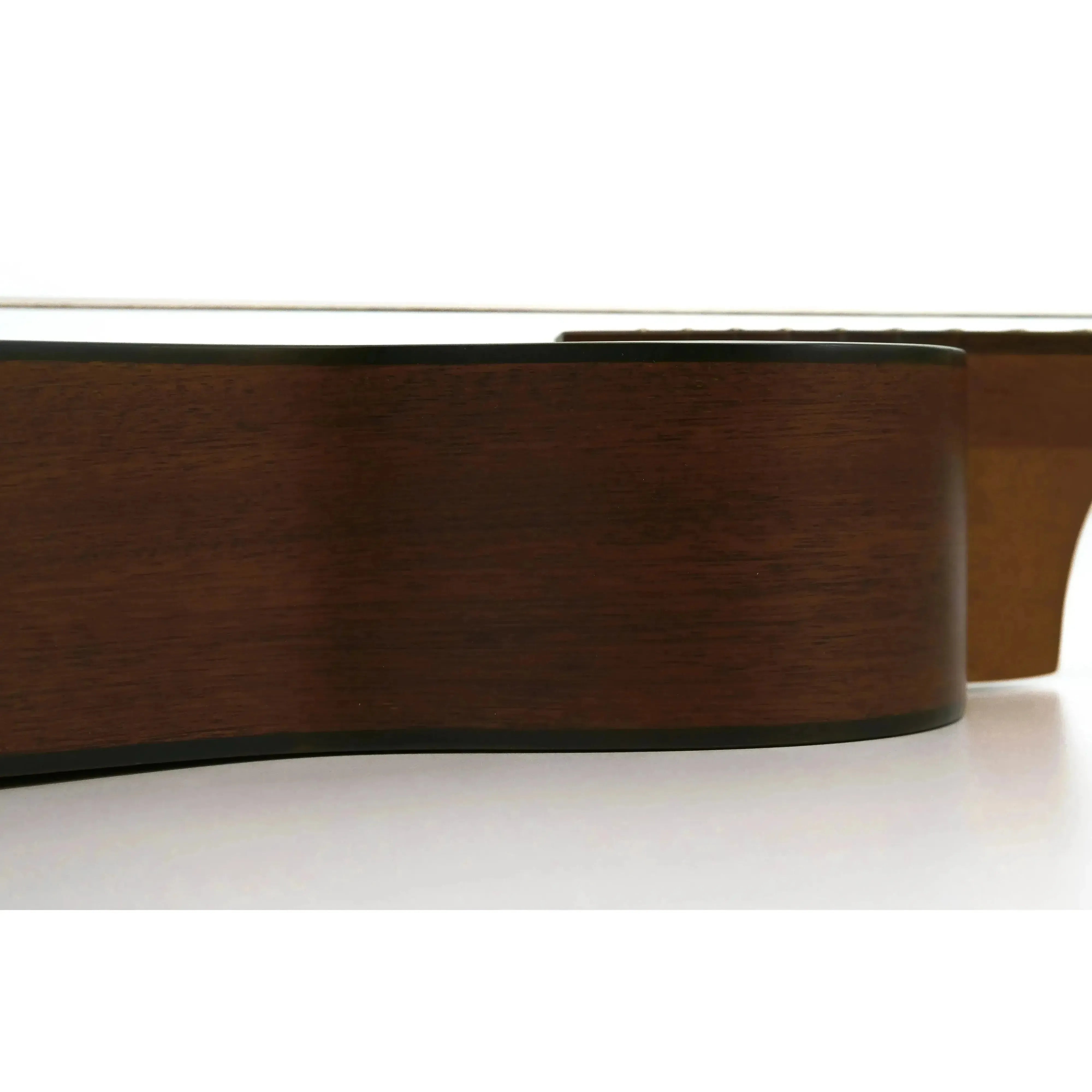 Side view of an Ohana BK-14 Baritone Ukulele, showing its dark mahogany body and black binding.