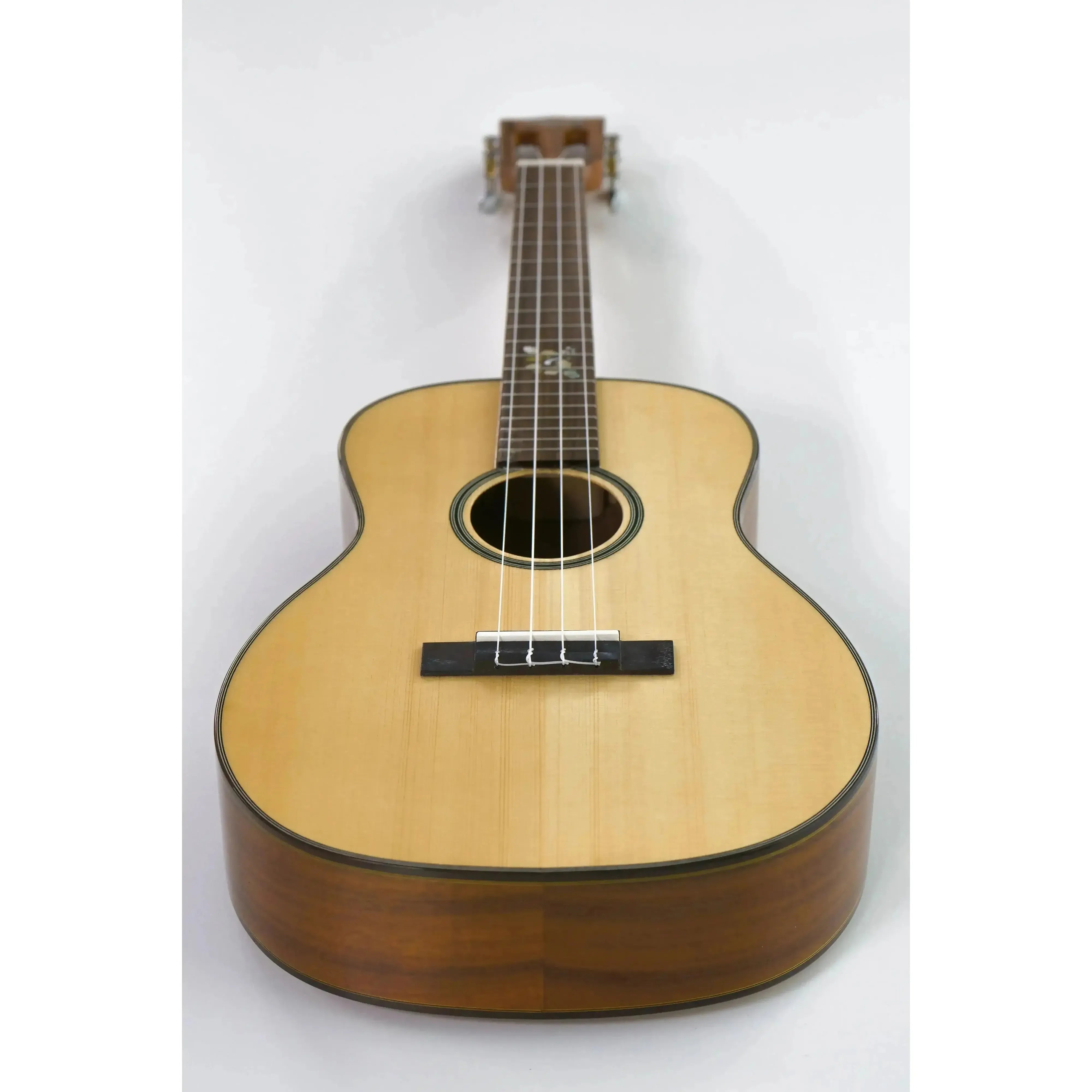 Ohana BKT-250G Baritone Ukulele with light spruce top, dark acacia sides, and floral fretboard inlay.