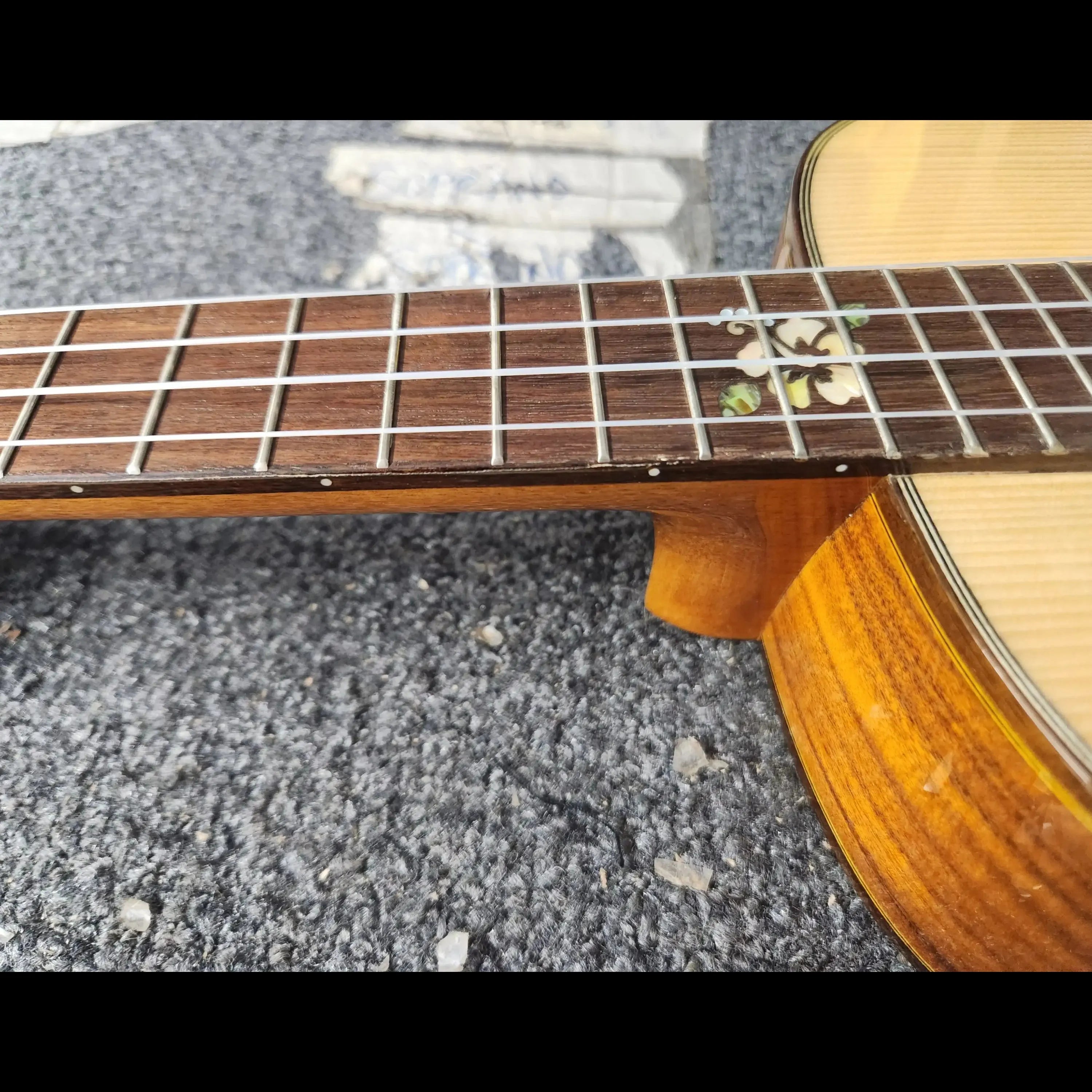 Ohana BKT-250G Baritone Ukulele fretboard with floral inlay and spruce top.