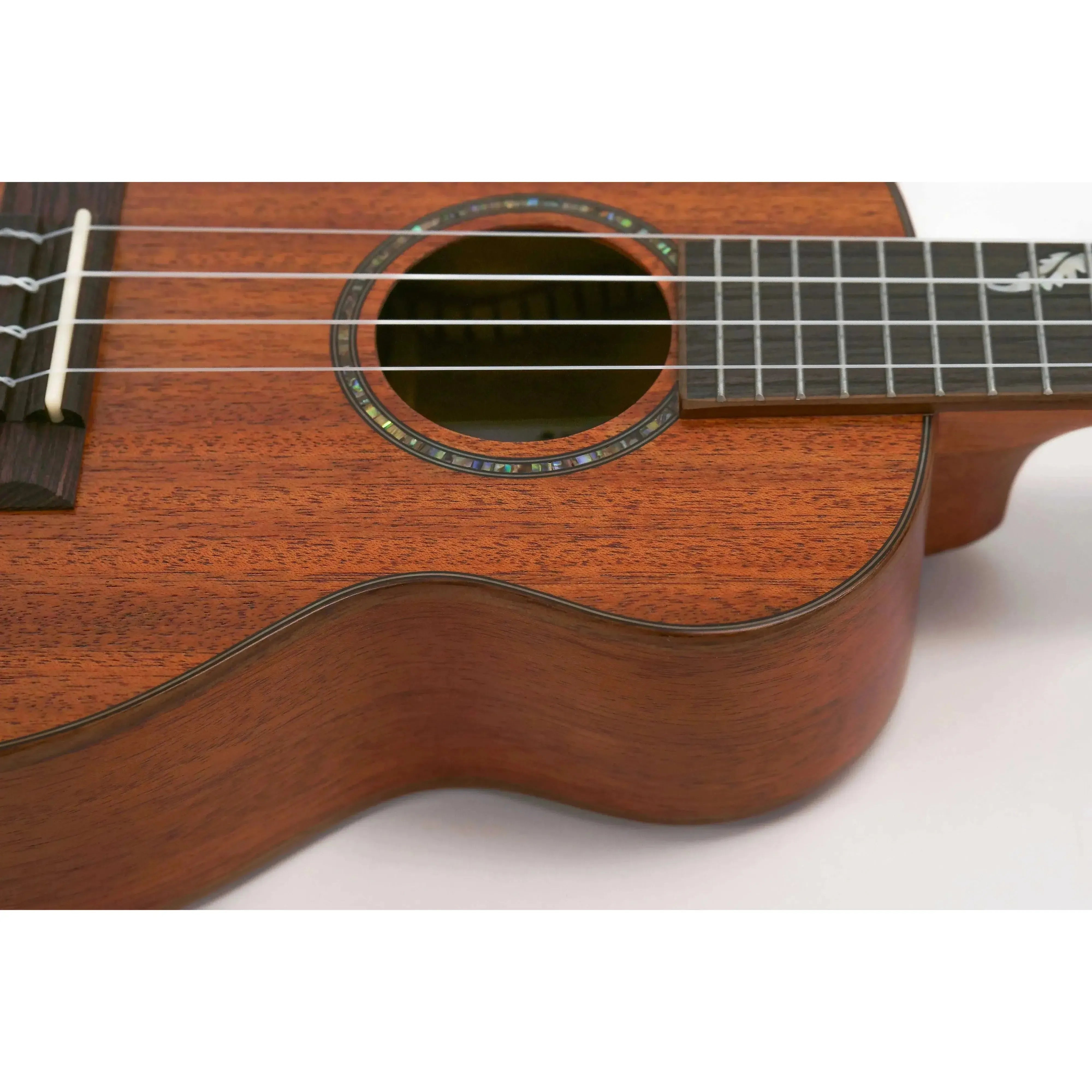 Ohana CK-32 Concert Ukulele, close-up of solid mahogany body with soundhole rosette and fretboard.