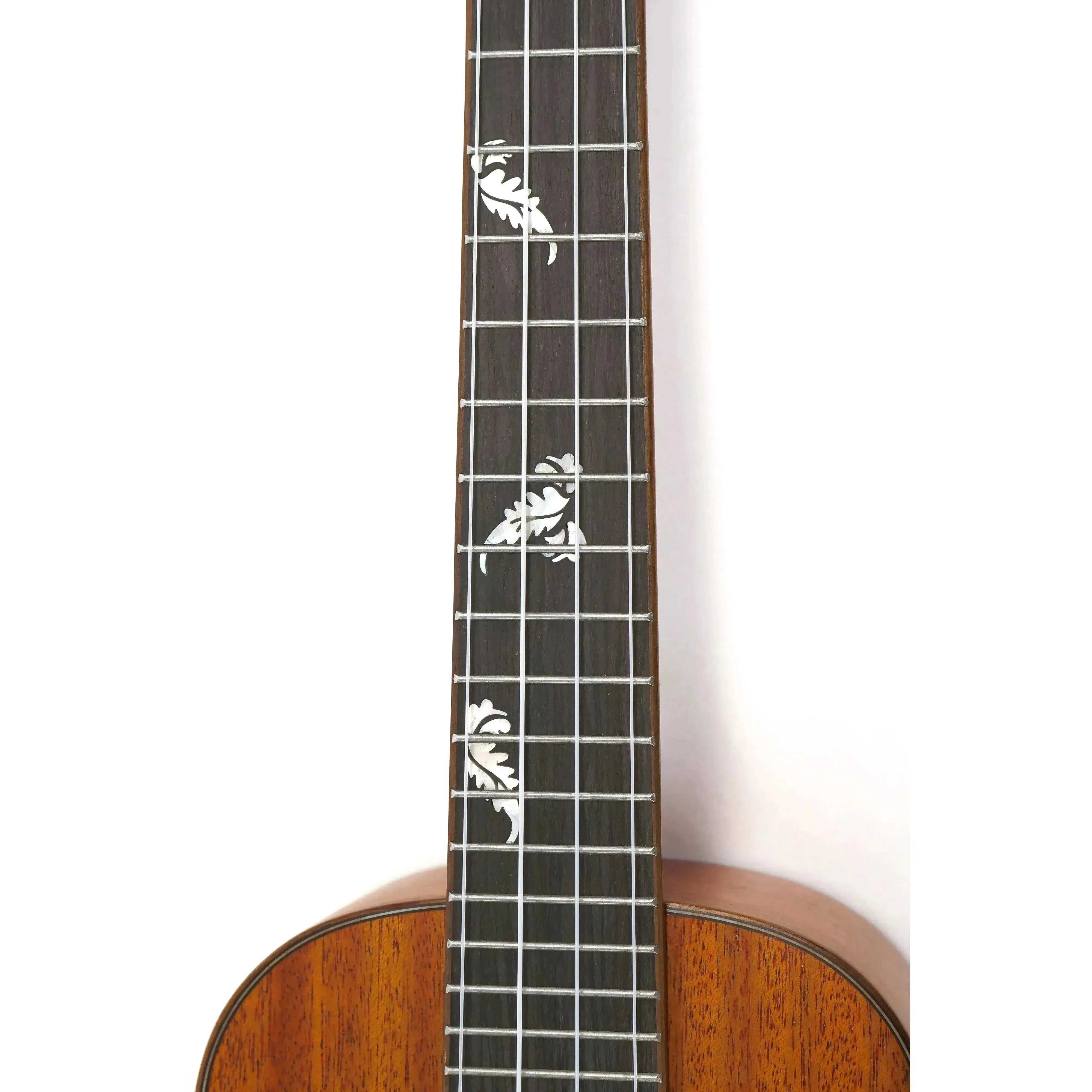 Ohana CK-32 Concert Ukulele fretboard with white floral inlay markers on dark wood.