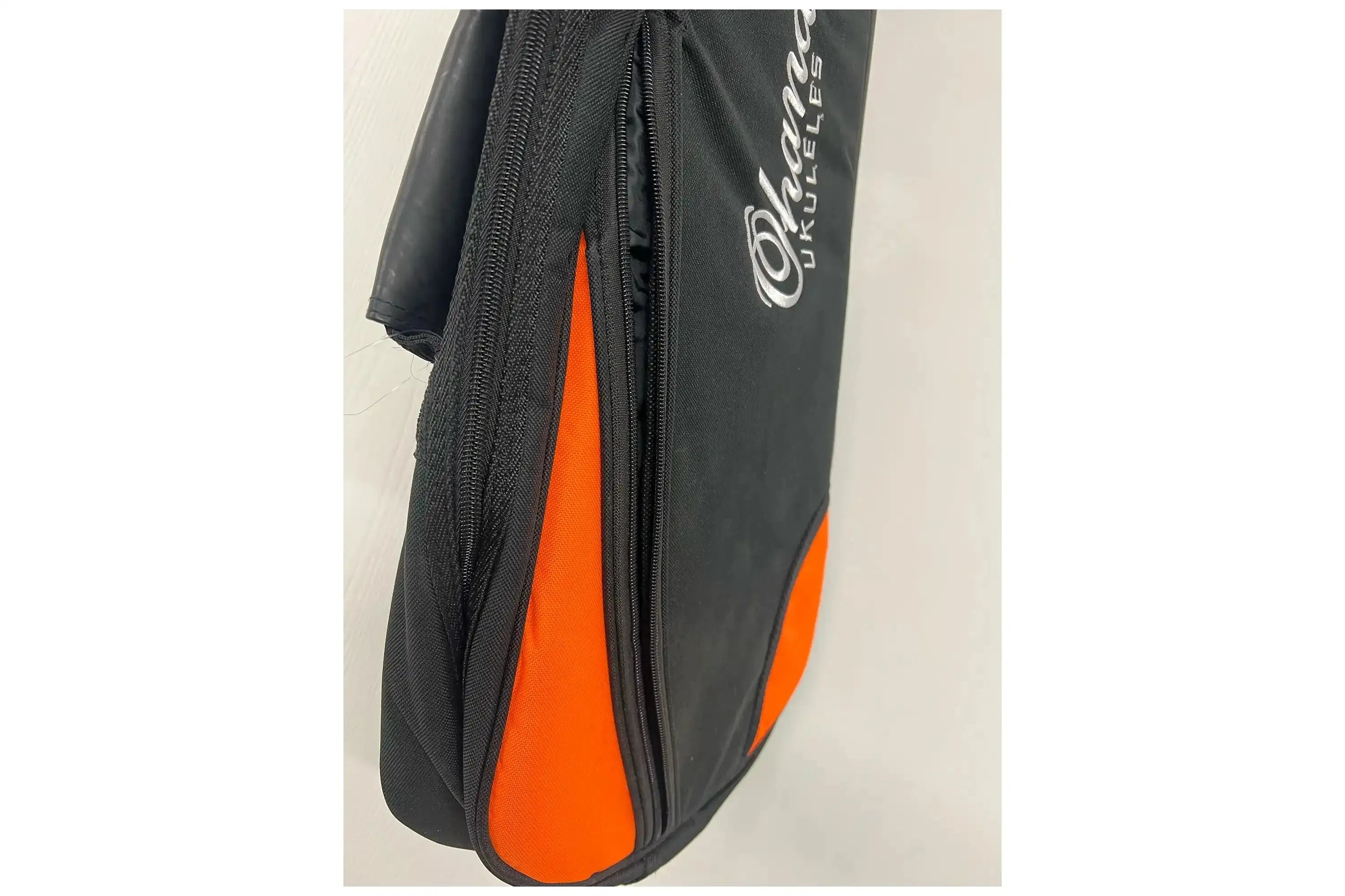 Ohana Deluxe Concert Ukulele Gigbag, black nylon with orange accents and embroidered logo.