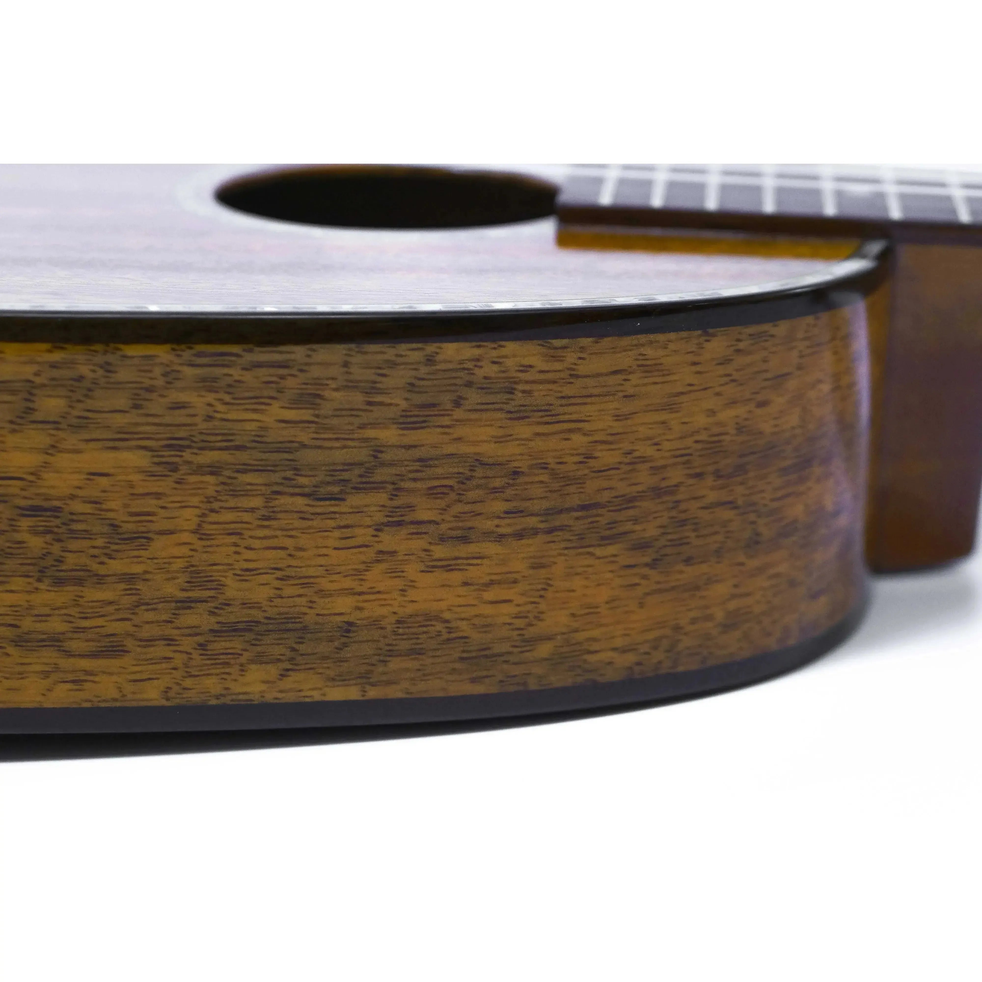 Close-up of Ohana PKT-220G ukulele's solid mango body with wood binding and gloss finish.