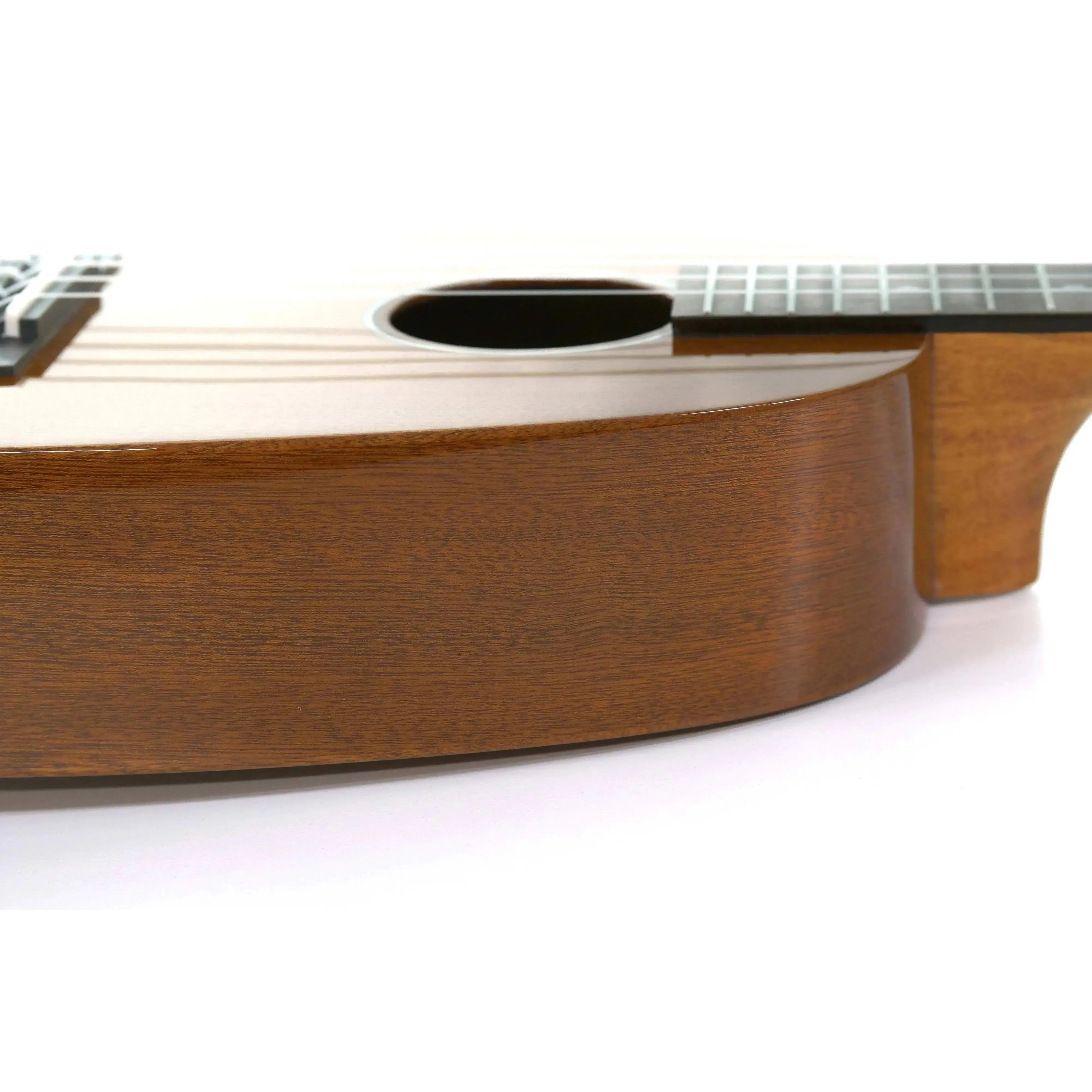 Ohana PKT-25G Pineapple Tenor Ukulele, close-up of the solid mahogany body with a natural wood grain.