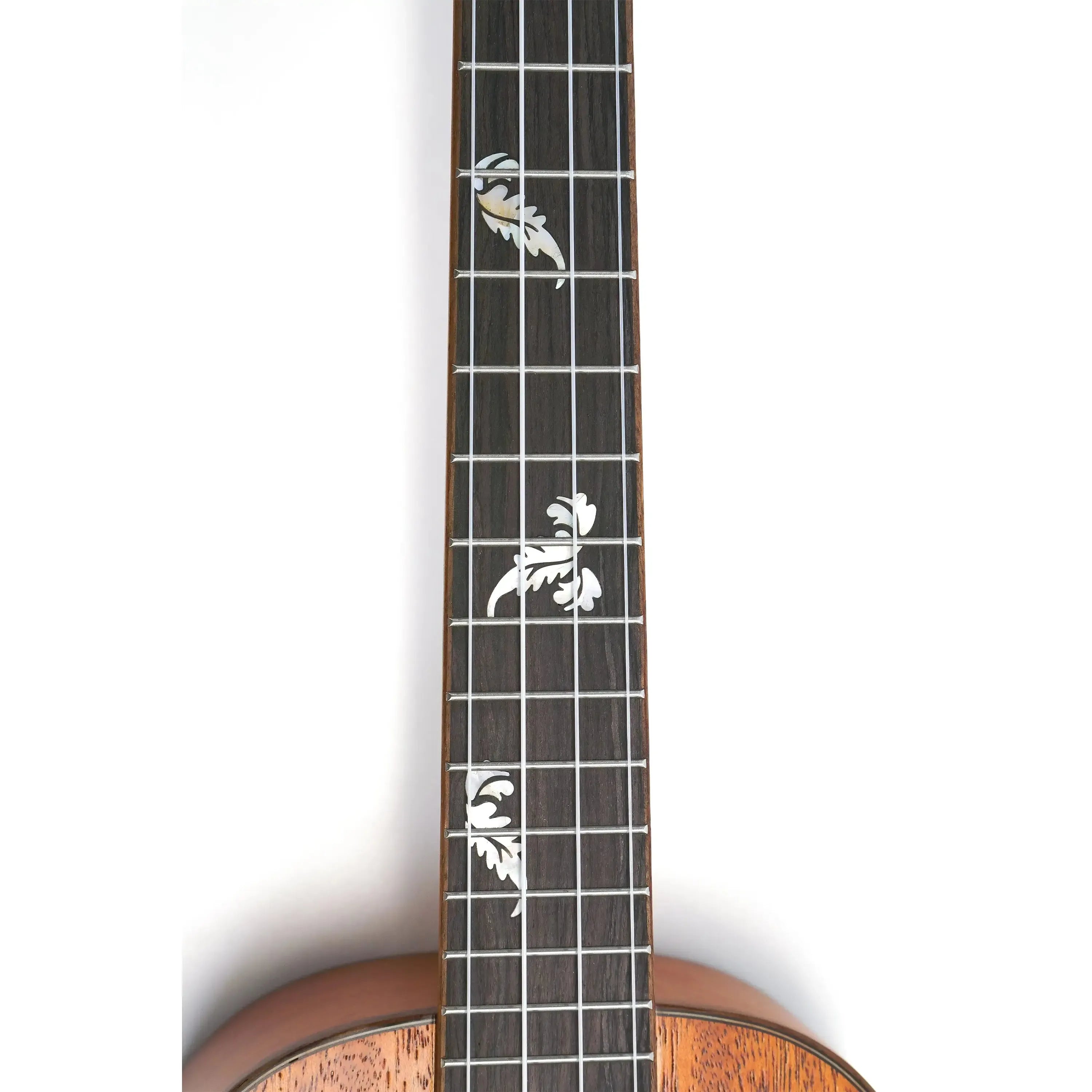 Ohana TK-32 tenor ukulele fretboard with white floral inlays on dark wood, showing part of the mahogany body.