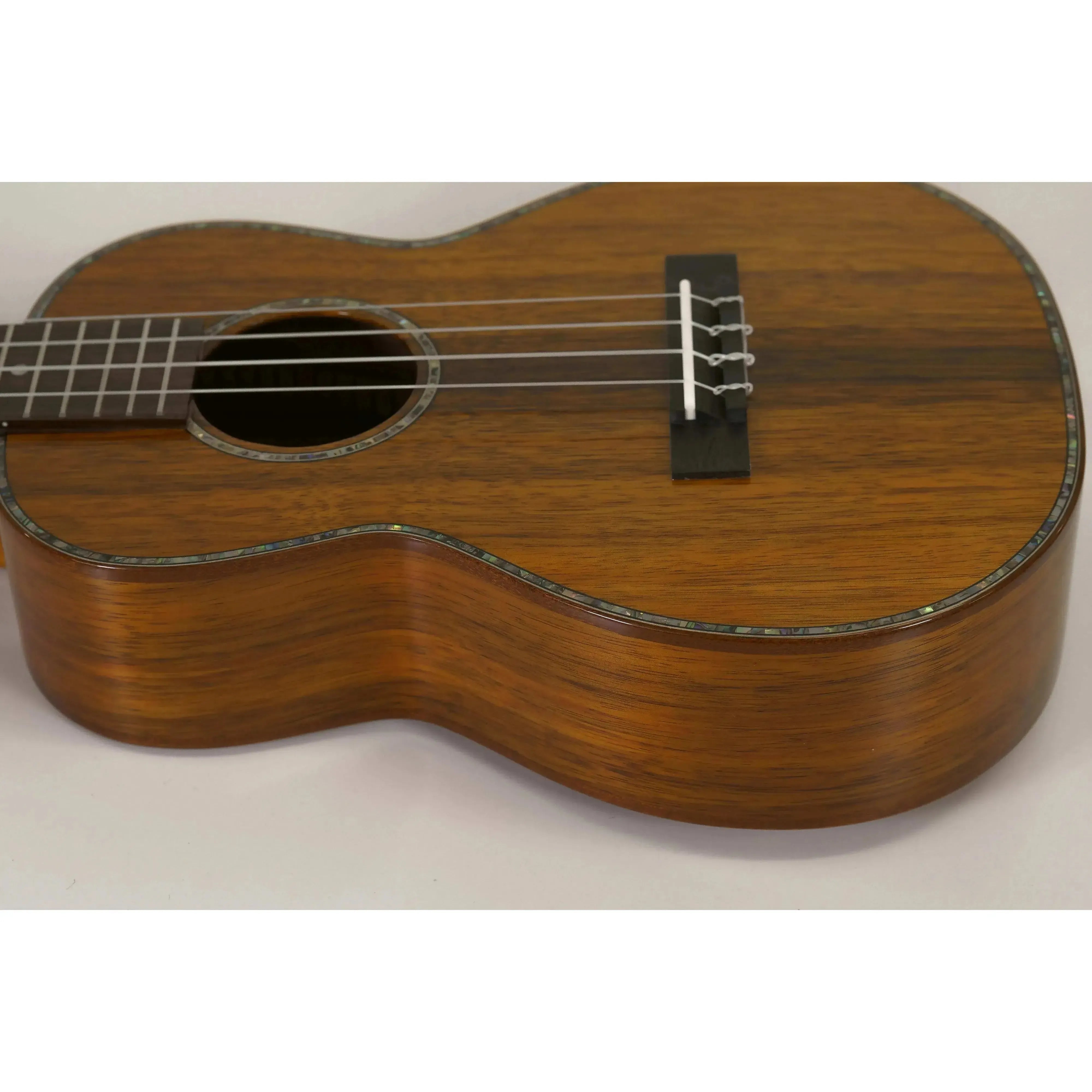 Ohana TK-350G Gloss Solid Hawaiian Koa Tenor Ukulele body with abalone inlay and mahogany binding.