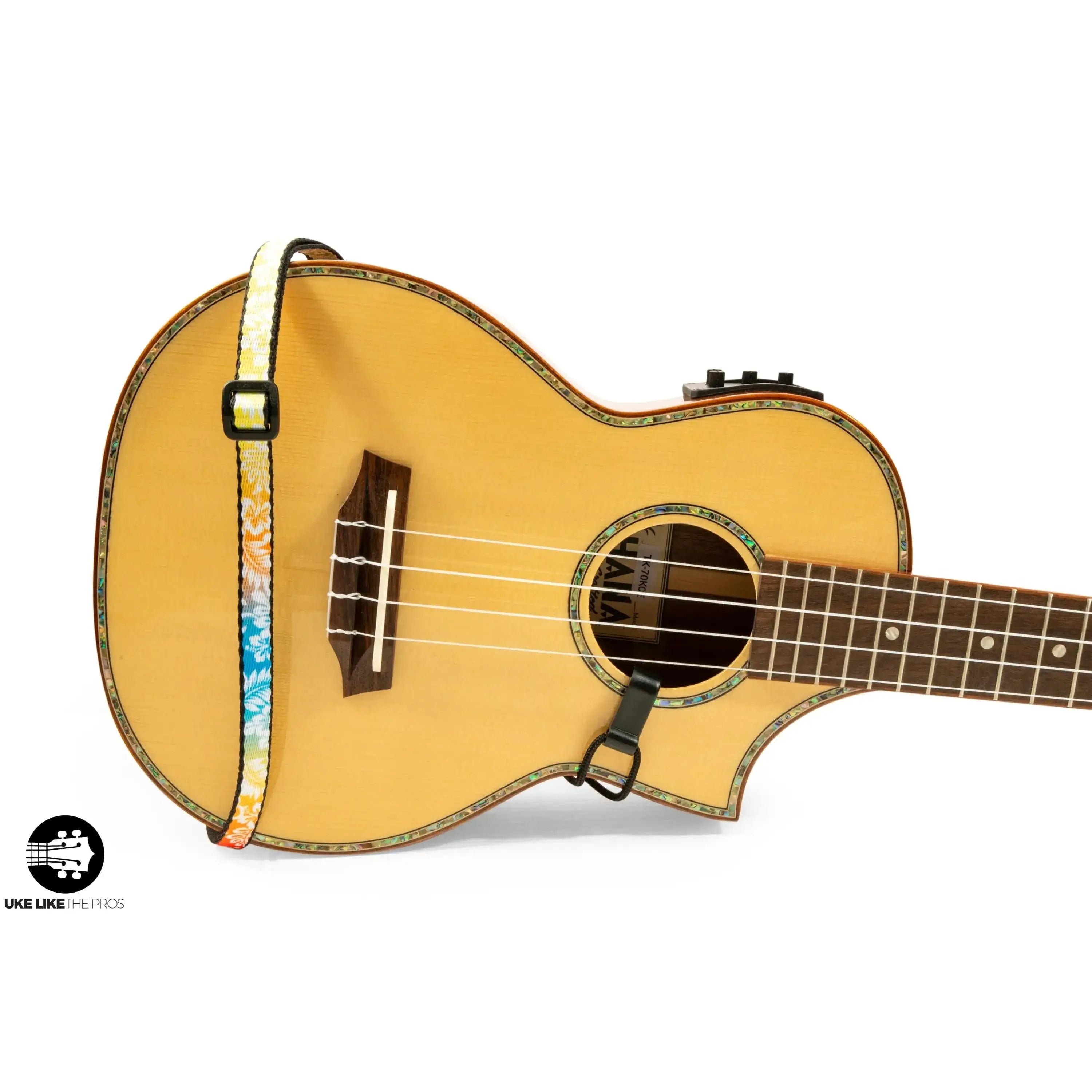 Ohana USS-04 ukulele sound hole strap, rainbow floral polyester, 0.5" wide, on a light wood ukulele.