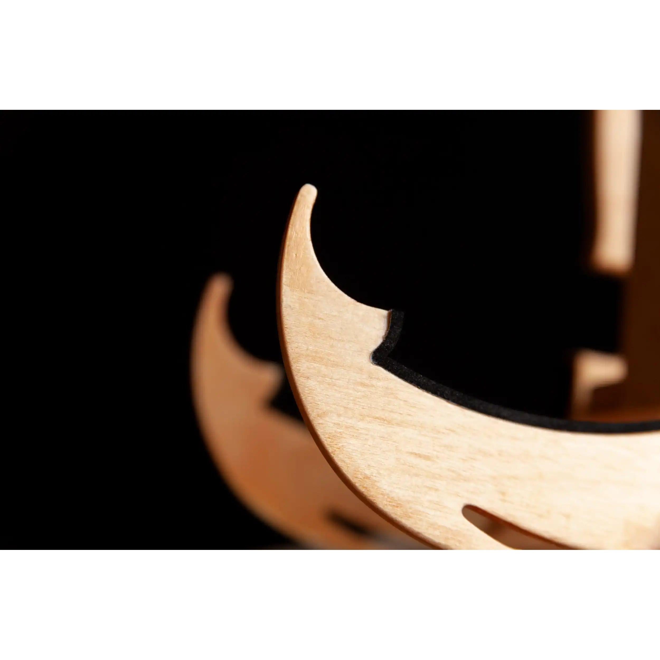 Close-up of natural wood instrument stand with black inlay at Terry Carter Music Store