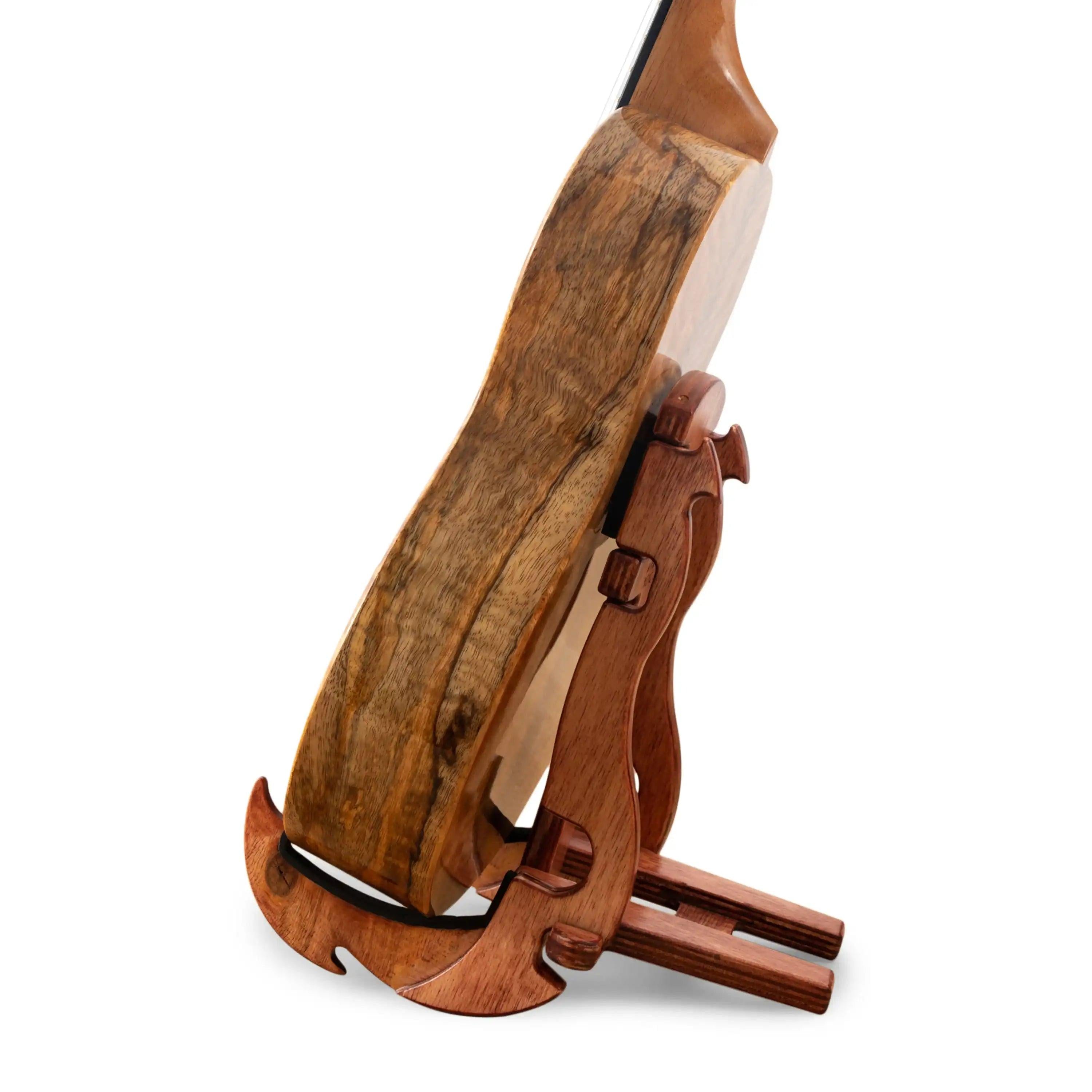Curly koa wood ukulele on wooden stand, side view at Terry Carter Music Store