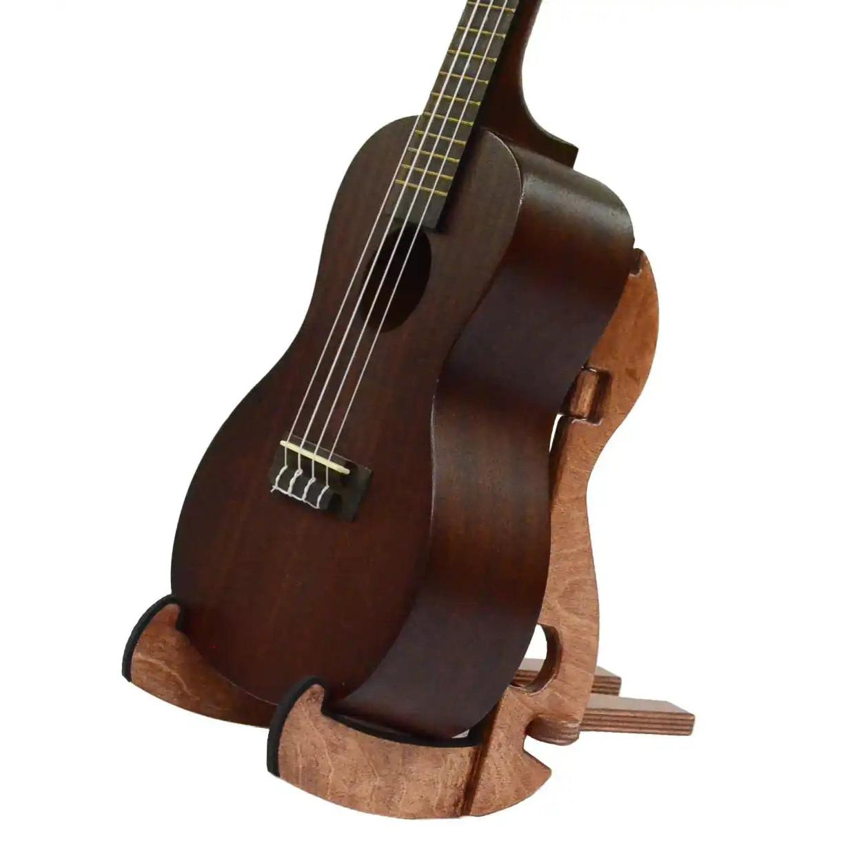 Matte finish ukulele with dark wood body on wooden stand, Terry Carter Music Store