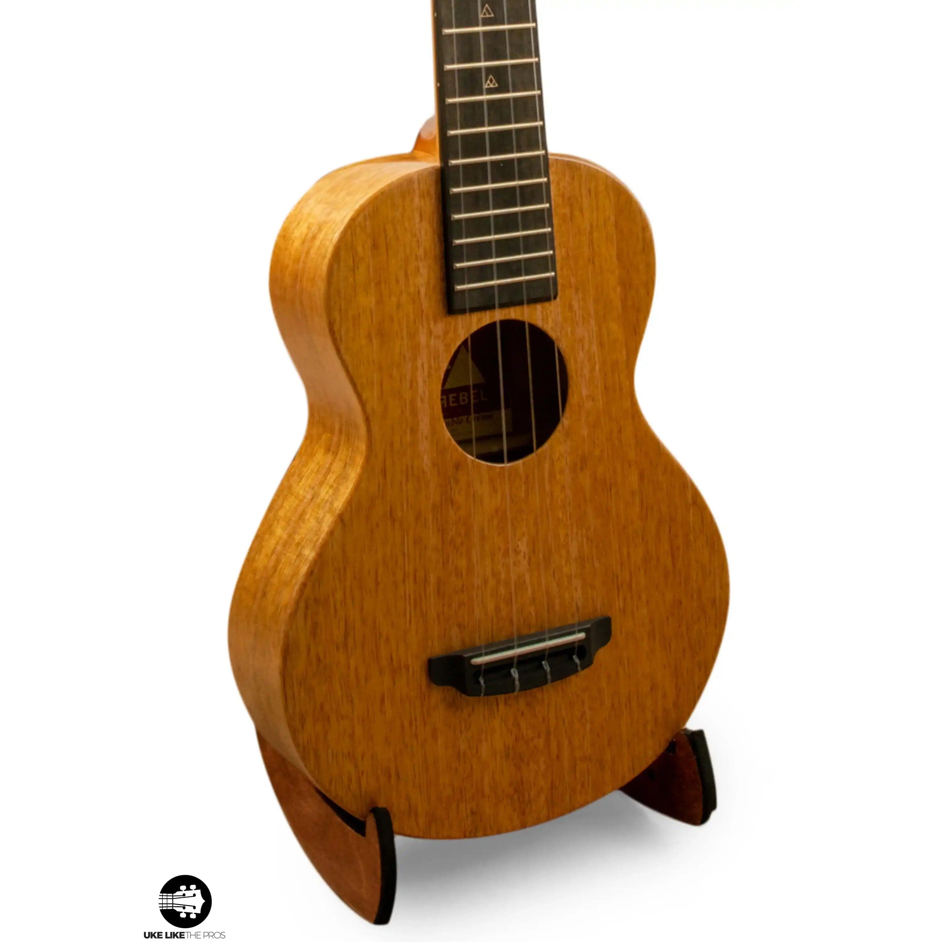 Rebel mahogany ukulele on stand, featured at Terry Carter Music Store.