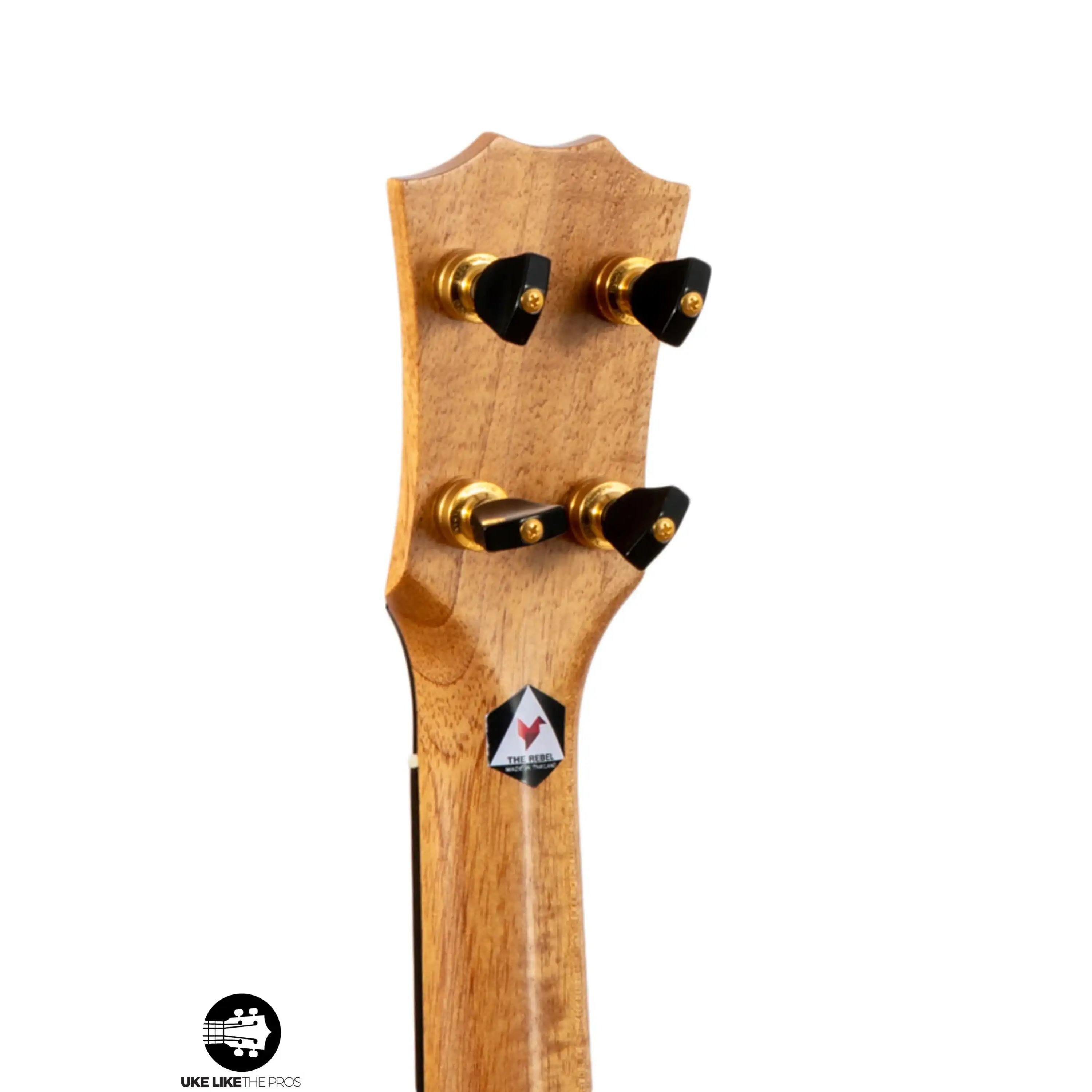 The Rebel ukulele headstock with gold tuners and natural wood finish at Terry Carter Music Store.