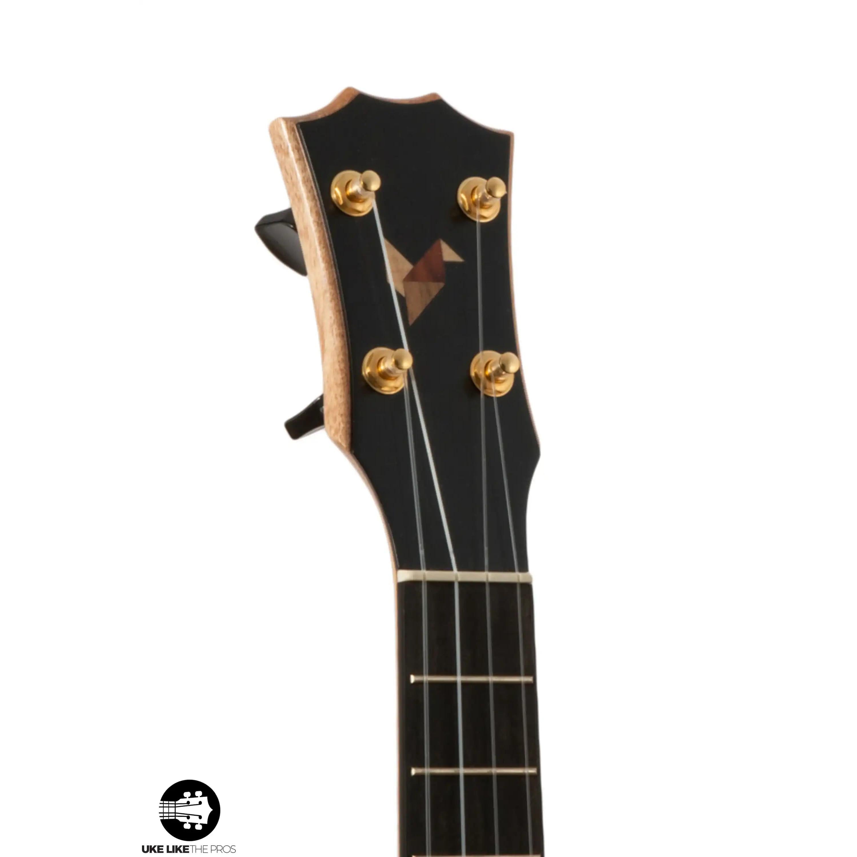 Romero Creations ukulele headstock with wood inlay, gold tuners, and ebony face at Terry Carter Music Store