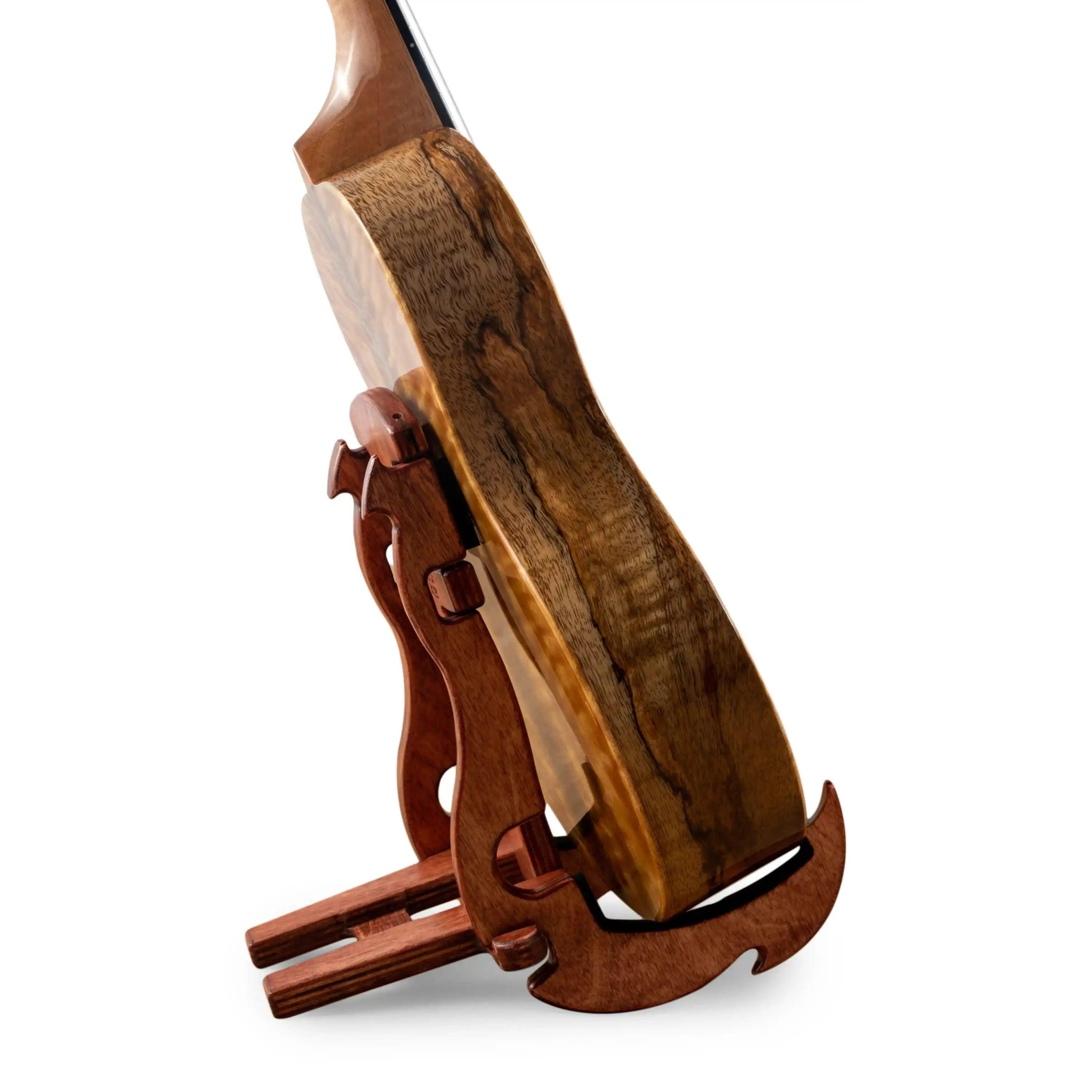 Wooden ukulele with figured wood grain on a wooden stand, Terry Carter Music Store.