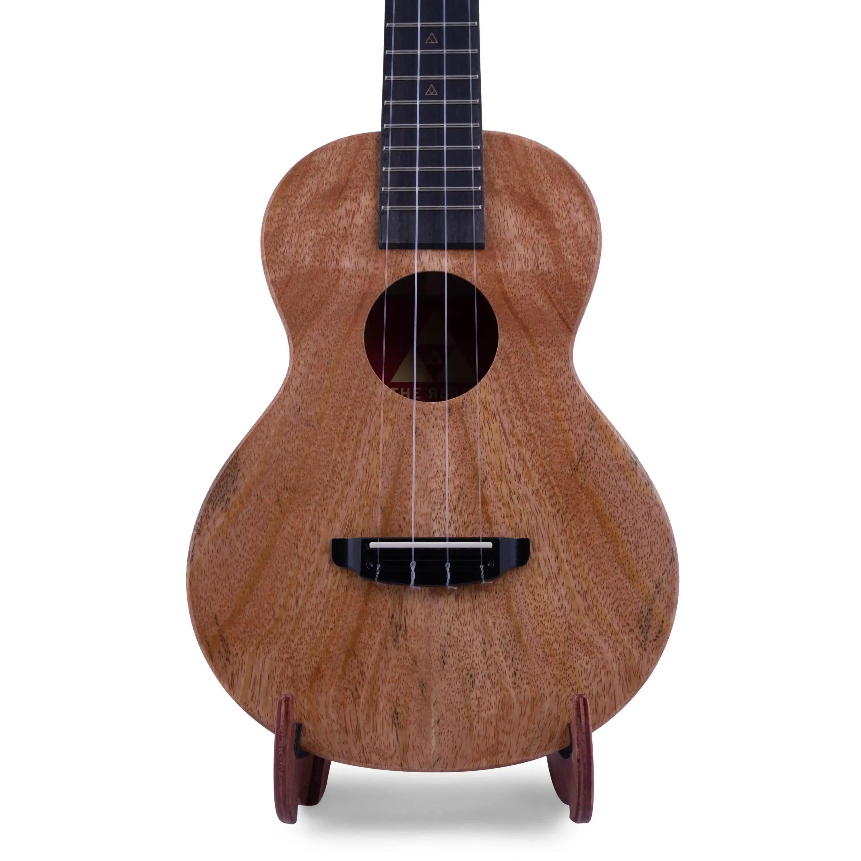 Rebel ukulele with natural wood grain finish on stand, product at Terry Carter Music Store.
